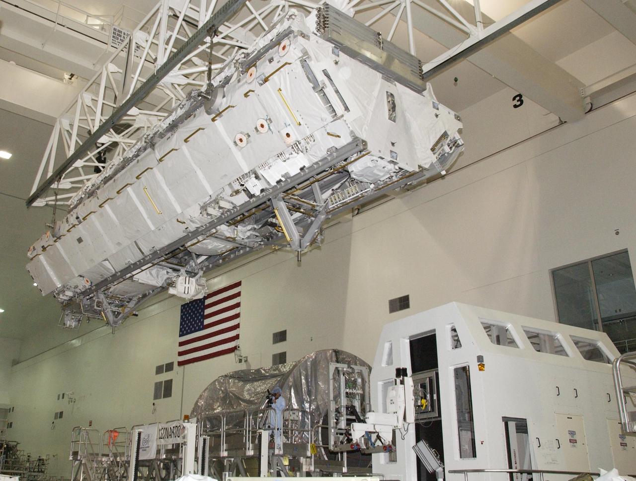 KENNEDY SPACE CENTER, FLA. -- An overhead crane moves the S1 Integrated Truss Structure above over other equipment to get to the payload canister for transport to Atlantis. The first starboard truss segment, the S1 will be attached to the Central truss segment, the S0 Truss, on the International Space Station during mission STS-112. Atlantis is scheduled to launch no earlier than Oct. 2.