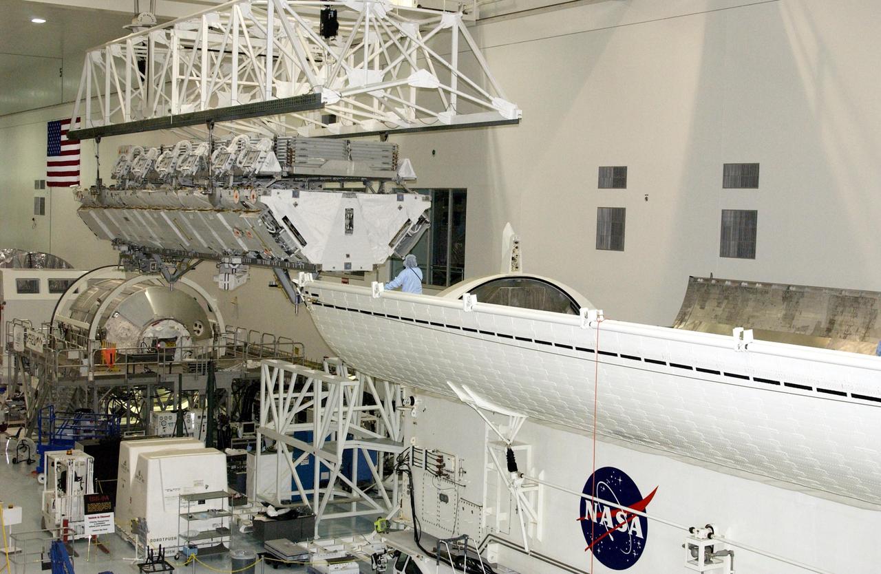 KENNEDY SPACE CENTER, FLA. -- An overhead crane moves the S1 Integrated Truss Structure toward the payload canister below, which will transport it to Atlantis. The first starboard truss segment, the S1 will be attached to the Central truss segment, the S0 Truss, on the International Space Station during mission STS-112. Atlantis is scheduled to launch no earlier than Oct. 2.