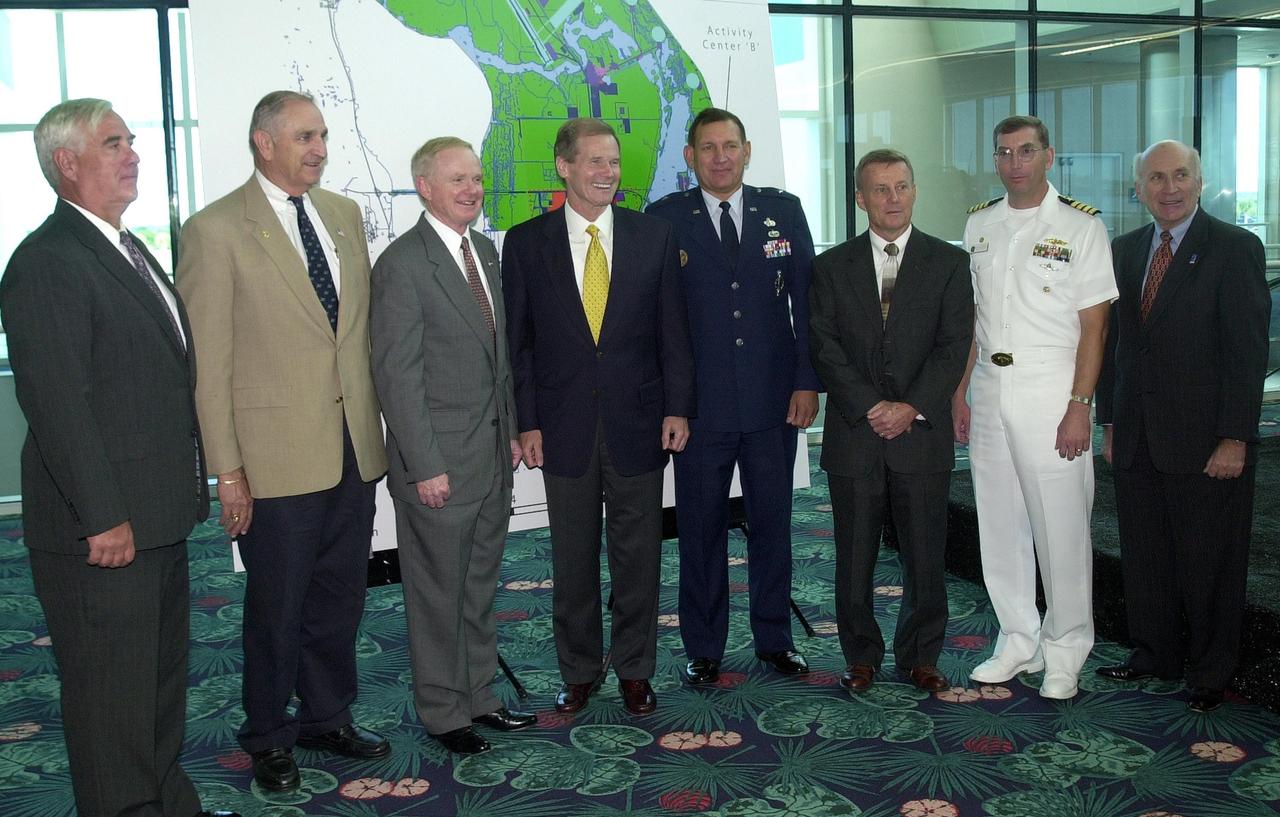 KENNEDY SPACE CENTER, FLA. -- Cape Canaveral Spaceport leaders gather after the master plan signing ceremony at Port Canaveral Terminal 10. From left are Canaveral National Seashore Superintendent Robert Newkirk, Canaveral Port Authority Executive Director Malcolm "Mac" McLouth, KSC Director Roy Bridges Jr., U.S. Sen. Bill Nelson, 45th Space Wing Commander Gregory Pavlovich, U.S. Fish & Wildlife Services Refuge Manager Ron Hight, Naval Ordnance Test Unit Commanding Officer William Borger, and Florida Space Authority Executive Director Ed Gormel. The plan represents interagency cooperation between the leadership group's  agencies and the U.S. Fish and Wildlife Service, the National Park Service and U.S. Navy.  Joining them in developing a vision of the Spaceport's future have been aerospace educators, researchers, and businesses, along with representatives from local, state and national government.