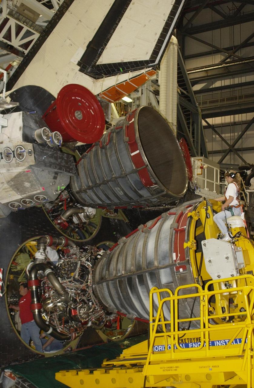 KENNEDY SPACE CENTER, FLA. --  The last engine is installed in orbiter Atlantis after a welding and polishing process was undertaken on flow liners where cracks were detected.   All engines were removed for inspection of flow liners.   Atlantis will next fly on mission STS-112,  scheduled for launch no earlier than Oct. 2.    