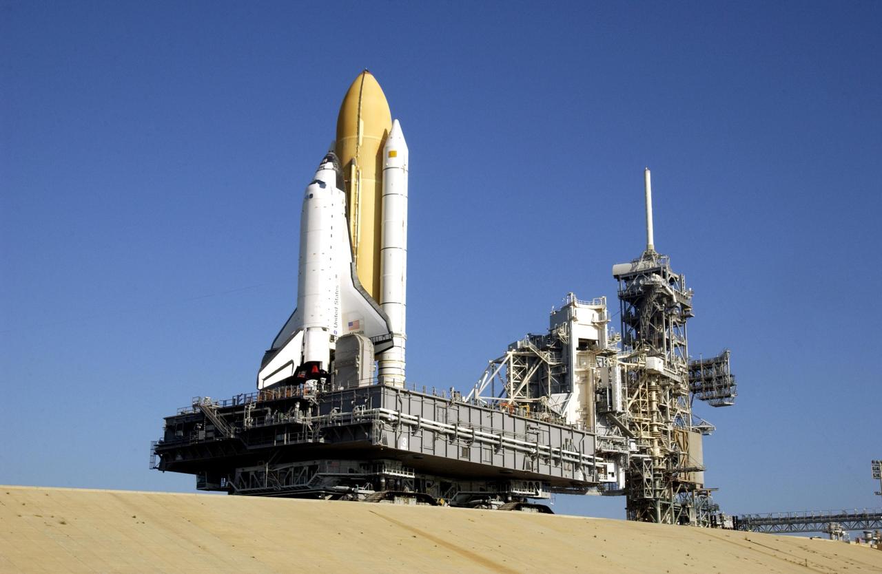 KENNEDY SPACE CENTER, FLA. -- After an early morning rollout, Space Shuttle Atlantis nears the top of the launch pad.  The Rotating Service Structure is wide open (in front of the Mobile Launcher Platform). After being stacked with its solid rocket boosters and external tank, Atlantis began its rollout to Launch Pad 39B at 2:27 a.m. EDT in preparation for launch to the International Space Station. The Shuttle arrived at the Pad and was hard down at 9:38 a.m. Launch is scheduled no earlier than Oct. 2 for mission STS-112, the 15th assembly flight to the International Space Station.  Atlantis will carry the S1 Integrated Truss Structure, which will be attached to the central truss segment, the S0 truss, during the mission.    