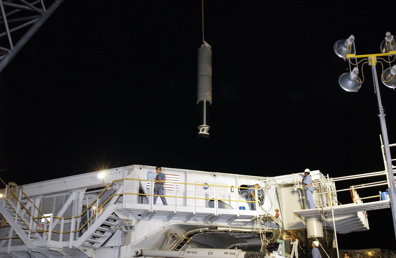 KENNEDY SPACE CENTER, FLA. --   The final Jacking, Equalization and Leveling (JEL) cylinder is moved to Crawler Transporter No. 2 (CT-2) for installation. During recent routine maintenance inspections, cracks were found on four bearings in two JEL cylinders. Further eddy current inspections indicated that cracks were present on 15 bearings. There are 16 cylinders and 32 bearings per crawler. CT-2 was repaired in order to enable Atlantis' rollout for mission STS-112, scheduled for launch no earlier than Oct. 2.    