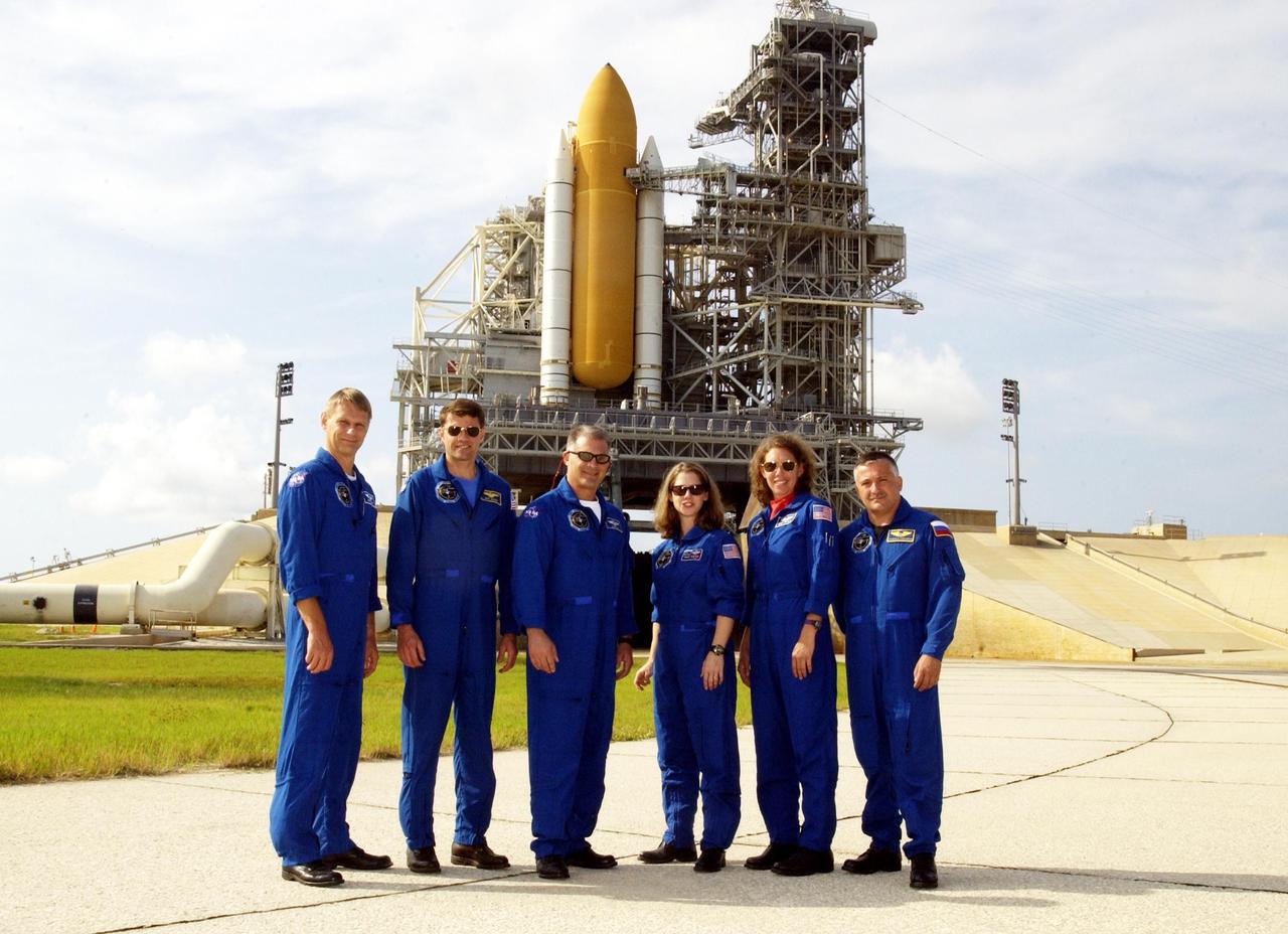 KENNEDY SPACE CENTER, FLA. --   During Terminal Countdown Demonstration Test activities, the STS-112 crew poses for a group photo near the launch pad where Space Shuttle Atlantis waits for launch.  Standing left to right are Mission Specialist Piers Sellers, Commander Jeffrey Ashby, Mission Specialist David Wolf, Pilot Pamela Melroy, and Mission Specialists Sandra Magnus and Fyodor Yurchikhin, who is with the Russian Space Agency.  The TCDT includes emergency egress training and a simulated launch countdown. Mission STS-112 aboard Space Shuttle Atlantis is scheduled to launch no earlier than Oct. 2, between 2 and 6 p.m. EDT.  STS-112 is the 15th assembly mission to the International Space Station.  Atlantis will be carrying the S1 Integrated Truss Structure, the first starboard truss segment, to be attached to the central truss segment, S0, and the Crew and Equipment Translation Aid (CETA) Cart A.  The CETA is the first of two human-powered carts that will ride along the ISS railway, providing mobile work platforms for future spacewalking astronauts.  