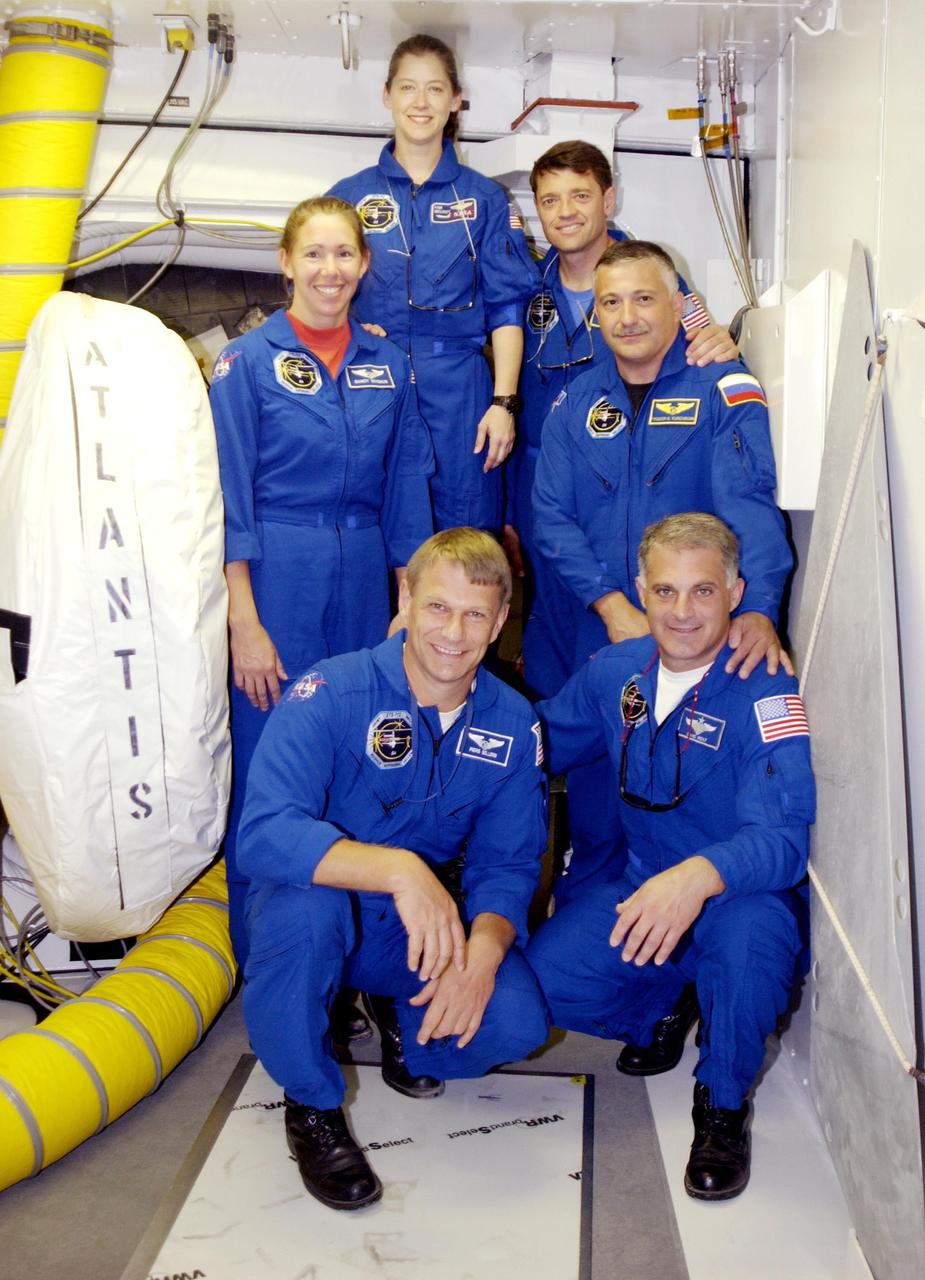 KENNEDY SPACE CENTER, FLA. -- The STS-112 crew pauses for a photo in the White Room during Terminal Countdown Demonstration Test activities.  Kneeling in front are Mission Specialists Piers Sellers and David Wolf;  standing, left to right, are Mission Specialist Sandra Magnus,  Pilot Pamela Melroy, Commander Jeffrey Ashby and Mission Specialist Fyodor Yurchikhin. (with the Russian Space Agency). Mission STS-112 aboard Space Shuttle Atlantis is scheduled to launch no earlier than Oct. 2, between 2 and 6 p.m. EDT.  STS-112 is the 15th assembly mission to the International Space Station.  Atlantis will be carrying the S1 Integrated Truss Structure, the first starboard truss segment, to be attached to the central truss segment, S0, and the Crew and Equipment Translation Aid (CETA) Cart A.  The CETA is the first of two human-powered carts that will ride along the ISS railway, providing mobile work platforms for future spacewalking astronauts.  
