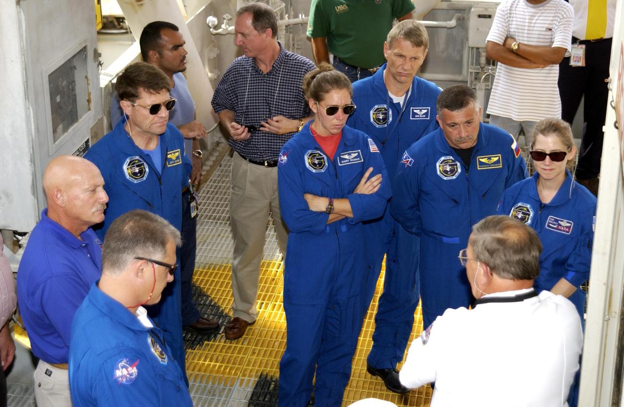 KENNEDY SPACE CENTER, FLA. --  During emergency egress training from the launch pad, the STS-112 crew listens to a trainer about use of the system.  The crew members are, from left in the center, Commander Jeffrey Ashby, Mission Specialists Sandra Magnus, Piers Sellers and Fyodor Yurchikhin; and Pilot Pamela Melroy.  In the foreground, left, is Mission Specialist David Wolf.  Yurchikhin is with the Russian Space Agency. The training is part of Terminal Countdown Demonstration Test activities, which include a simulated launch countdown.  Mission STS-112 aboard Space Shuttle Atlantis is scheduled to launch no earlier than Oct. 2, between 2 and 6 p.m. EDT.  STS-112 is the 15th assembly mission to the International Space Station.  Atlantis will be carrying the S1 Integrated Truss Structure, the first starboard truss segment, to be attached to the central truss segment, S0, and the Crew and Equipment Translation Aid (CETA) Cart A.  The CETA is the first of two human-powered carts that will ride along the ISS railway, providing mobile work platforms for future spacewalking astronauts.  