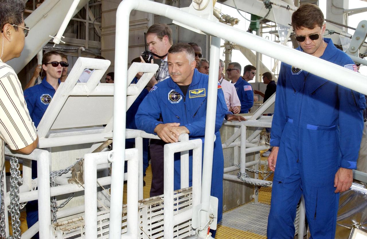 KENNEDY SPACE CENTER, FLA. --  In the foreground, STS-112 Pilot Pamela Melroy (left), Mission Specialist Fyodor Yurchikhin (center) and Commander Jeffrey Ashby (right) watch as a slidewire basket descends to the landing area.  The crew is taking part in emergency egress training from the pad, part of Terminal Countdown Demonstration Test activities. Mission STS-112 aboard Space Shuttle Atlantis is scheduled to launch no earlier than Oct. 2, between 2 and 6 p.m. EDT.  STS-112 is the 15th assembly mission to the International Space Station.  Atlantis will be carrying the S1 Integrated Truss Structure, the first starboard truss segment, to be attached to the central truss segment, S0, and the Crew and Equipment Translation Aid (CETA) Cart A.  The CETA is the first of two human-powered carts that will ride along the ISS railway, providing mobile work platforms for future spacewalking astronauts.  