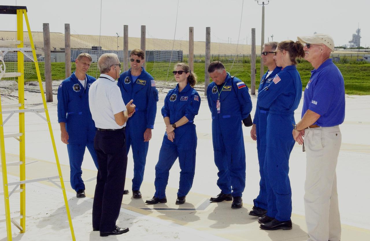 KENNEDY SPACE CENTER, FLA. --  The STS-112 crew listen to further instructions about emergency egress from the Shuttle.  Standing, left to right, are Mission Specialist Piers Sellers, Commander Jeffrey Ashby, Pilot Pamela Melroy, Mission Specialists Fyodor Yurchikhin (with the Russian Space Agency), David Wolf and Sandra Magnus. The training is part of Terminal Countdown Demonstration Test activities, which include a simulated launch countdown.  Mission STS-112 aboard Space Shuttle Atlantis is scheduled to launch no earlier than Oct. 2, between 2 and 6 p.m. EDT.  STS-112 is the 15th assembly mission to the International Space Station.  Atlantis will be carrying the S1 Integrated Truss Structure, the first starboard truss segment, to be attached to the central truss segment, S0, and the Crew and Equipment Translation Aid (CETA) Cart A.  The CETA is the first of two human-powered carts that will ride along the ISS railway, providing mobile work platforms for future spacewalking astronauts.  
