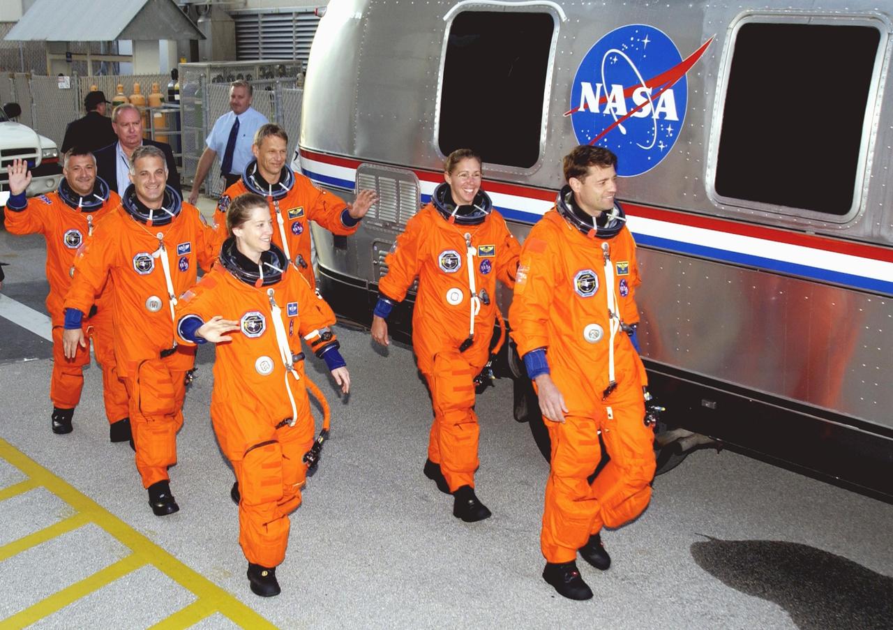 KENNEDY SPACE CENTER, FLA. --   The STS-112 crew heads for the Astrovan and a ride to the launch pad for a simulated countdown.  From left are Mission Specialists Fyodor Yurchikhin (RSA), David Wolf and Piers Sellers; Pilot Pamela Melroy; Mission Specialist Sandra Magnus; and Commander Jeffrey Ashby. Mission STS-112 aboard Space Shuttle Atlantis is scheduled to launch no earlier than Oct. 2, between 2 and 6 p.m. EDT.  STS-112 is the 15th assembly mission to the International Space Station.  Atlantis will be carrying the S1 Integrated Truss Structure, the first starboard truss segment, to be attached to the central truss segment, S0, and the Crew and Equipment Translation Aid (CETA) Cart A.  The CETA is the first of two human-powered carts that will ride along the ISS railway, providing mobile work platforms for future spacewalking astronauts.  