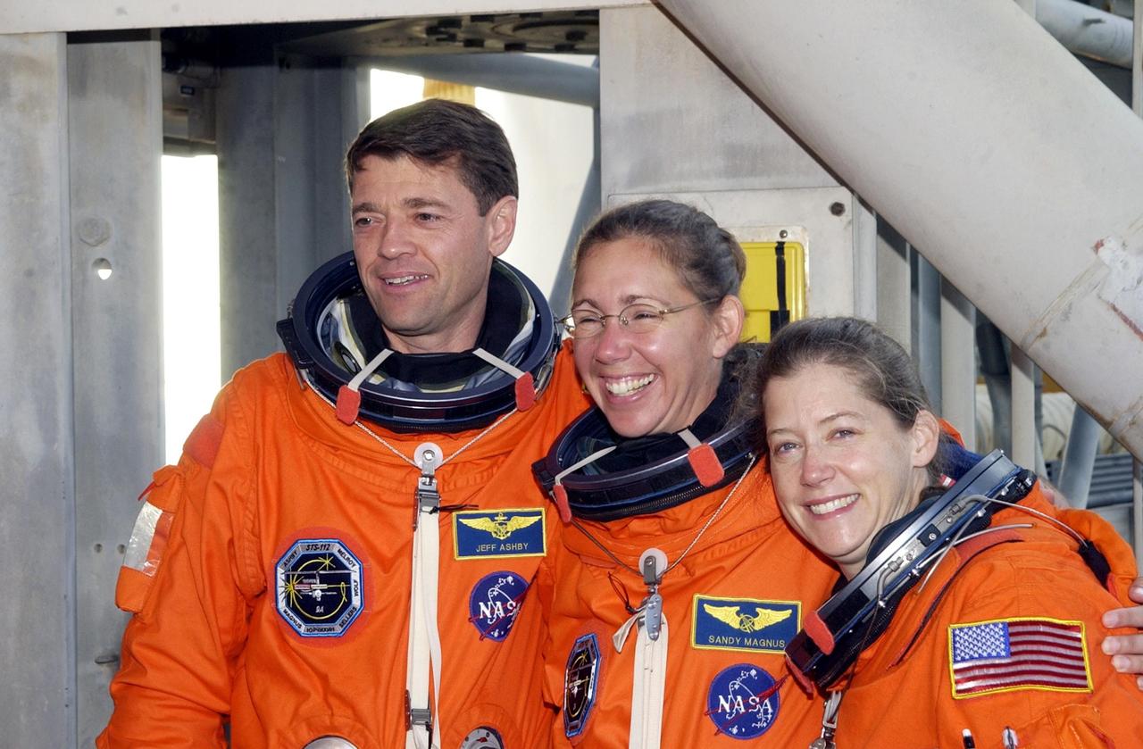 KENNEDY SPACE CENTER, FLA. -- STS-112 Commander Jeffrey Ashby, Mission Specialist Sandra Magnus, and Pilot Pamela Melroy take a momentary break from training at Pad 39B during Terminal Countdown Demonstration Test activities, which include a simulated launch countdown.  Launch of STS-112 aboard Space Shuttle Atlantis is scheduled for Oct. 2, between 2 and 6 p.m. EDT.  STS-112 is the 15th assembly mission to the International Space Station.  Atlantis will be carrying the S1 Integrated Truss Structure, the first starboard truss segment, to be attached to the central truss segment, S0, and the Crew and Equipment Translation Aid (CETA) Cart A.  The CETA is the first of two human-powered carts that will ride along the ISS railway, providing mobile work platforms for future spacewalking astronauts.  