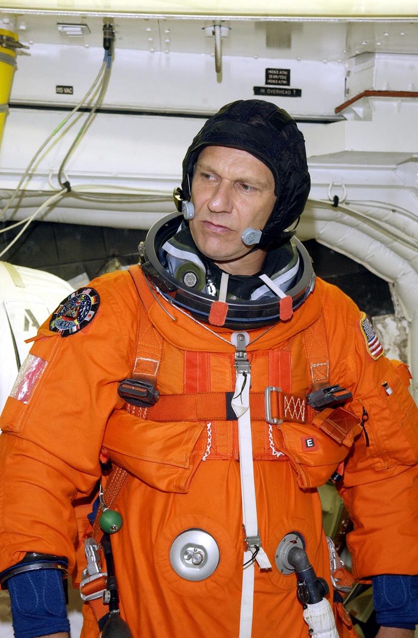 KENNEDY SPACE CENTER, FLA. -- In the White Room at Launch Pad 39B, STS-112  Mission Specialist Piers Sellers, Ph.D., prepares to enter Space Shuttle Atlantis during a simulated launch countdown, part of Terminal Countdown Demonstration Test activities, a dress rehearsal for launch.  Launch of STS-112 aboard Space Shuttle Atlantis is scheduled for Oct. 2, between 2 and 6 p.m. EDT.  STS-112 is the 15th assembly mission to the International Space Station.  Atlantis will be carrying the S1 Integrated Truss Structure, the first starboard truss segment, which will be attached to the central truss segment, S0, and the Crew and Equipment Translation Aid (CETA) Cart A.  The CETA is the first of two human-powered carts that will ride along the ISS railway, providing mobile work platforms for future spacewalking astronauts.  
