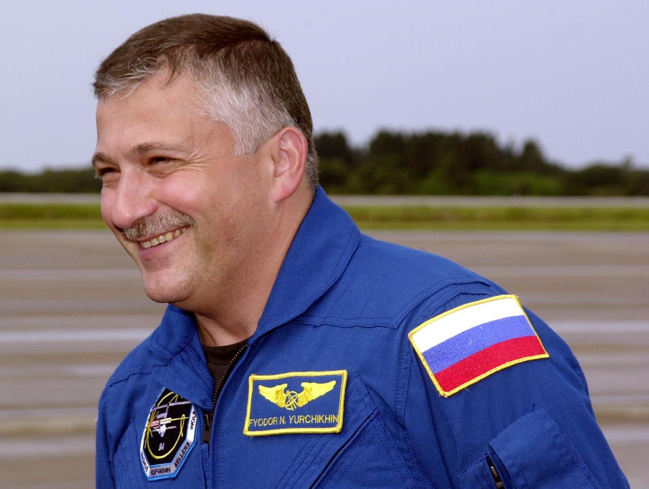 KENNEDY SPACE CENTER, FLA. -- STS-112 Mission Specialist Fyodor Yurchikhin, who is with the Russian Space Agency, shows his happiness at returning to KSC to prepare for launch. He will be making his first Shuttle flight. STS-112, aboard Space Shuttle Atlantis, is the 15th assembly mission to the International Space Station. Atlantis will be carrying the S1 Integrated Truss Structure, the first starboard truss segment, to be attached to the central truss segment, S0, and the Crew and Equipment Translation Aid (CETA) Cart A. The CETA is the first of two human-powered carts that will ride along the ISS railway, providing mobile work platforms for future spacewalking astronauts. The 11-day mission includes three spacewalks. Launch is scheduled for Oct. 2 between 2 and 6 p.m.