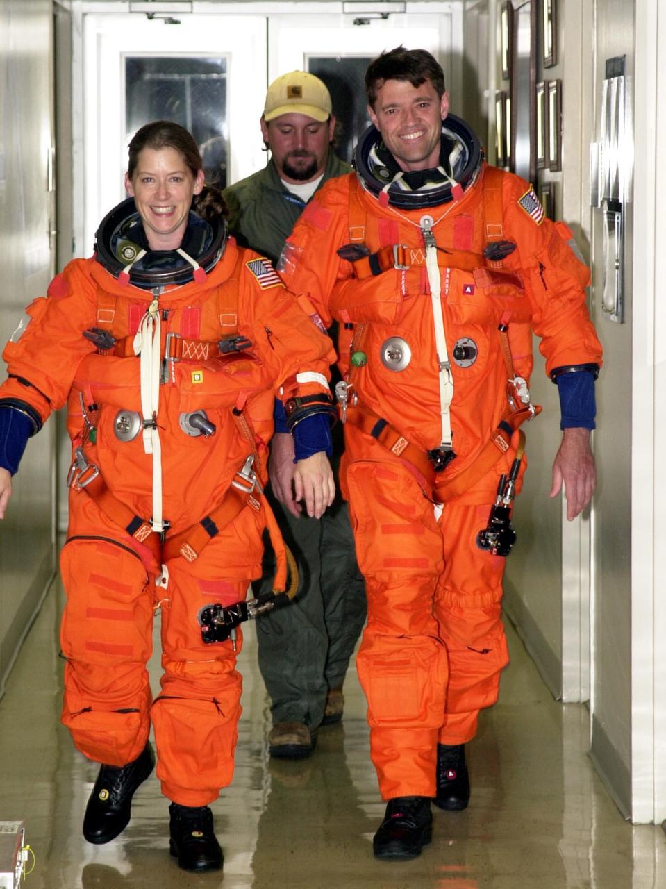 KENNEDY SPACE CENTER, FLA. --STS-112 Pilot Pamela Melroy (left) and Commander Jeffrey Ashby are suited up and ready to participate in landing exercises in the Shuttle Training Aircraft at the Shuttle Landing Facility.