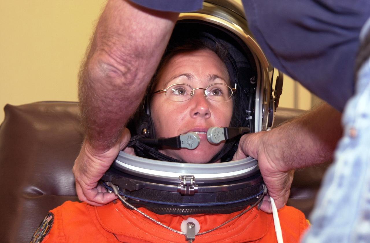KENNEDY SPACE CENTER, FLA. --STS-112 Mission Specialist  Sandra Magnus dons her space helmet for a final fit check in preparation for her launch to the International Space Station aboard Atlantis.  Launch is scheduled for Oct. 2 between 2 and 6 p.m. EDT.