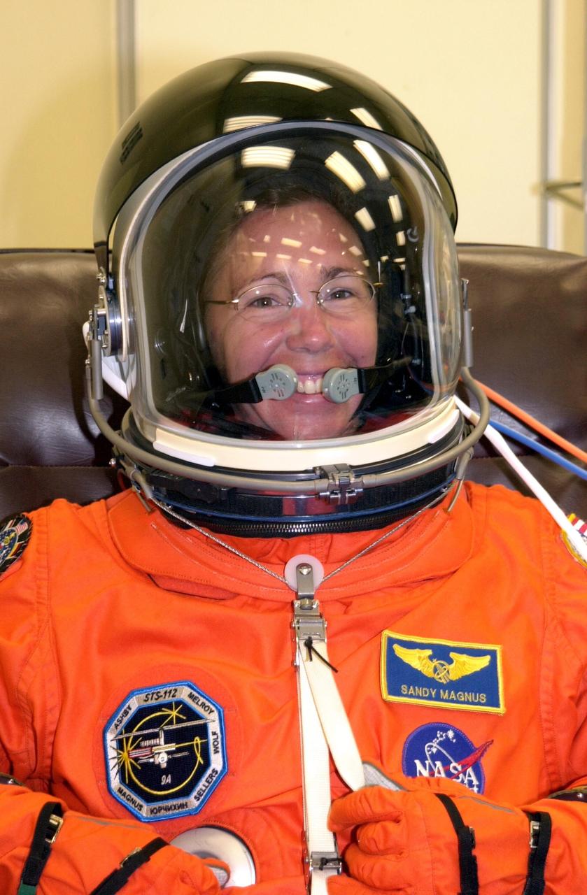 KENNEDY SPACE CENTER, FLA. --STS-112 Mission Specialist  Sandra Magnus dons her spacesuit for a final fit check in preparation for her launch to the International Space Station aboard Atlantis.  Launch is scheduled for Oct. 2 between 2 and 6 p.m. EDT.