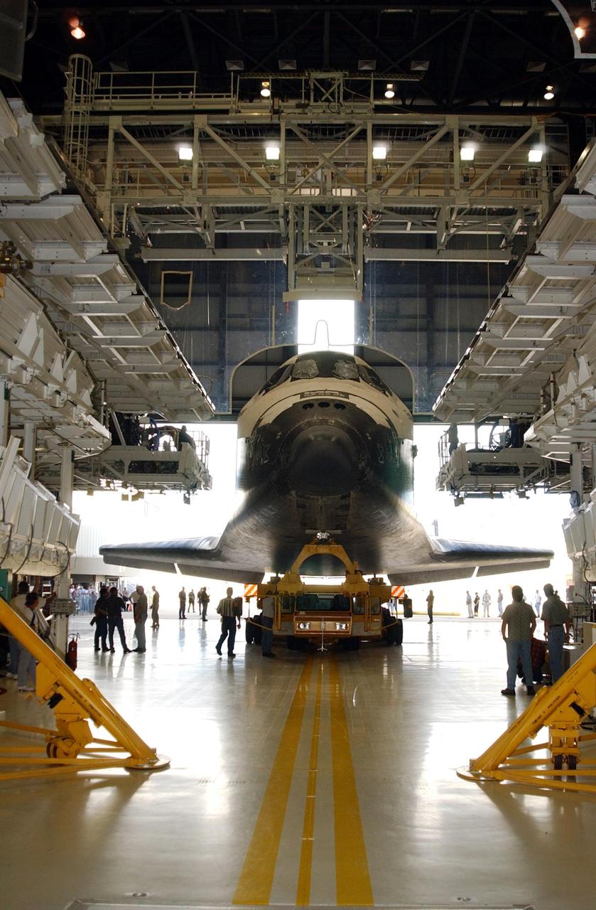 KENNEDY SPACE CENTER, FLA. -- Orbiter Endeavour begins rolling out of the Orbiter Processing Facility for its rollover to the Vehicle Assembly Building and continued launch preparations. Endeavour is scheduled to launch Nov. 10 on mission STS-113, the 16th assembly flight to the International Space Station. The primary payloads on mission STS-113 are the first port truss segment, P1 Truss and the Crew and Equipment Translation Aid (CETA) Cart B. . Once delivered, the P1 truss will remain stowed until flight 12A.1 in 2003 when it will be attached to the central truss segment, S0, on the Space Station. The CETA Cart B can be used by spacewalkers to move along the truss with equipment The mission will also deliver the Expedition 6 crew to the Station and return Expedition 5 to Earth.