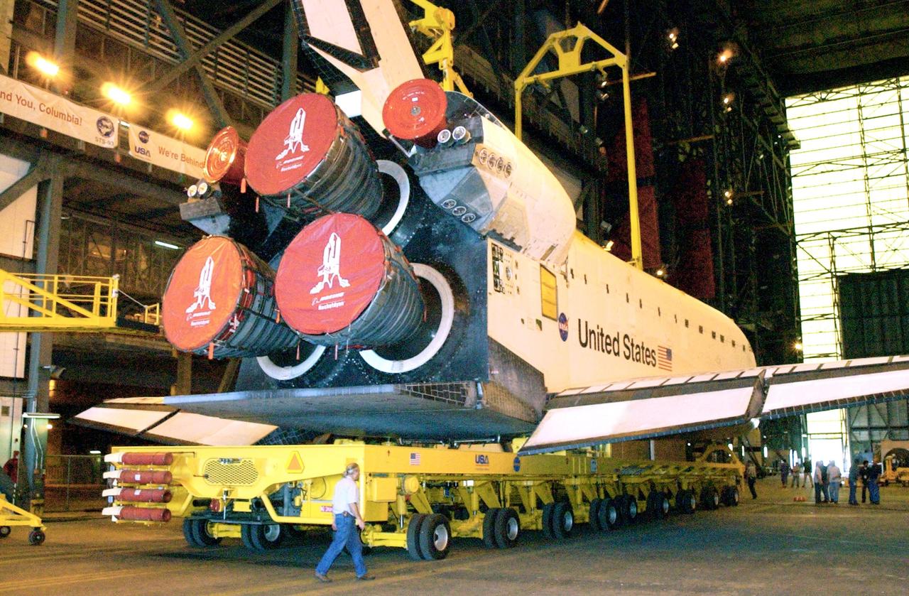 KENNEDY SPACE CENTER, FLA. -- In the transfer aisle of the Vehicle Assembly Building, overhead cranes are lowered toward orbiter Endeavour for its lift to vertical. Endeavour is scheduled to launch Nov. 10 on mission STS-113, the 16th assembly flight to the International Space Station. The primary payloads on mission STS-113 are the first port truss segment, P1 Truss and the Crew and Equipment Translation Aid (CETA) Cart B. . Once delivered, the P1 truss will remain stowed until flight 12A.1 in 2003 when it will be attached to the central truss segment, S0, on the Space Station. The CETA Cart B can be used by spacewalkers to move along the truss with equipment The mission will also deliver the Expedition 6 crew to the Station and return Expedition 5 to Earth.
