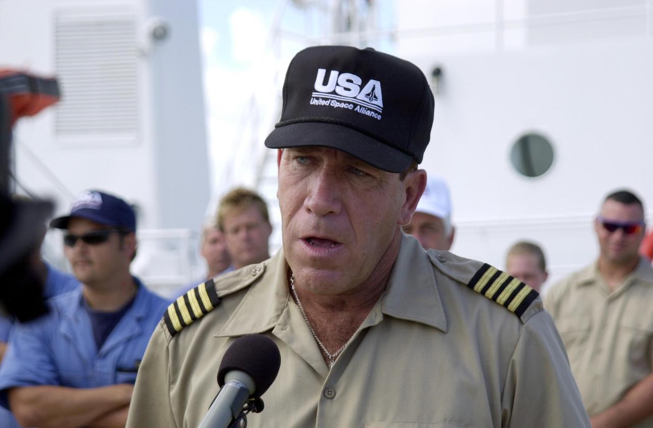 KENNEDY SPACE CENTER, FLA. - At the Hangar AF docks, Cape Canaveral Air Force Station, the captain of the Freedom Star, David Fraine, addresses those attending a reunion of a diver, Jack Wilcox, and his rescuers: the crew of KSC's Freedom Star Solid Rocket Booster (SRB) retrieval ship and a medical team. The diver suffered decompression sickness on a diving expedition 20 miles offshore in the Atlantic Ocean. When the Freedom Star team heard the call for help, they asked the Coast Guard if they could assist. The ship was out on a crane certification exercise and coincidentally had a diver medical technician and other divers training on the crane. The ship's divers were trained for the hyperbaric chamber on board. Upon reaching the Army dock, KSC Occupational Health physician Skip Beeler entered the chamber and continued the process of helping to stabilize Wilcox. After several hours in the chamber, Wilcox, who lives in Orlando, was airlifted to Florida Hospital Orlando.