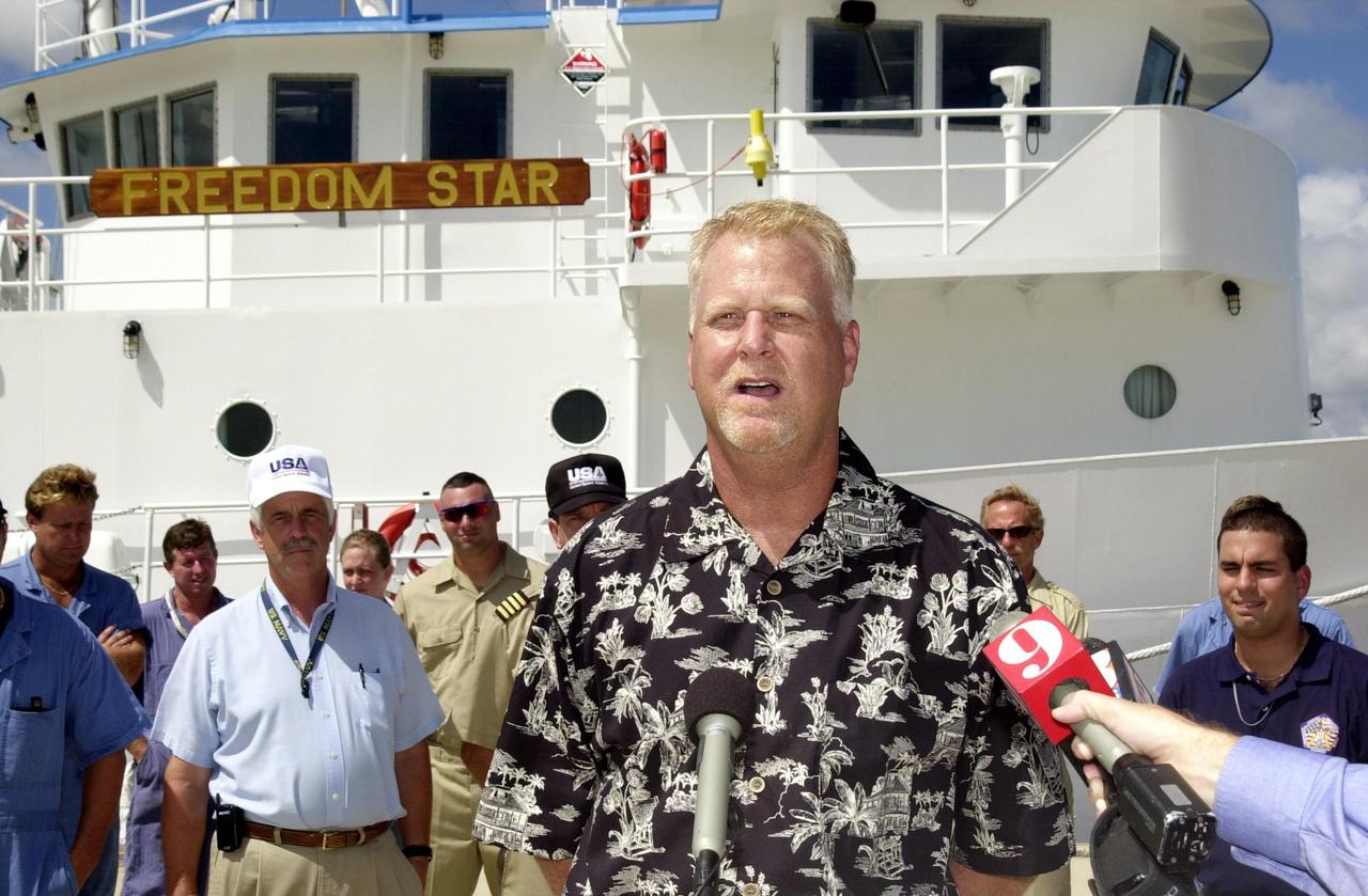 KENNEDY SPACE CENTER, FLA. -  Jack Wilcox answers questions from the media during a reunion at the Hangar AF docks, Cape Canaveral Air Force Station, with his rescuers.  Wilcox reunited with the men aboard KSC's Freedom Star SRB retrieval ship that was in the vicinity when Wilcox suffered decompression sickness on a diving expedition 20 miles off shore in the Atlantic Ocean. When the Freedom Star team heard the call for help, they asked the Coast Guard if they could assist. The ship was out on a crane certification exercise and coincidentally had a diver medical technician and other divers training on the crane. The ship's divers were trained for the hyperbaric chamber on board.  Upon reaching the Army dock, KSC Occupational Health physician Skip Beeler entered the chamber and continued the process of helping to stabilize Wilcox. After several hours in the chamber, Wilcox, who lives in Orlando, was airlifted to Florida Hospital Orlando.