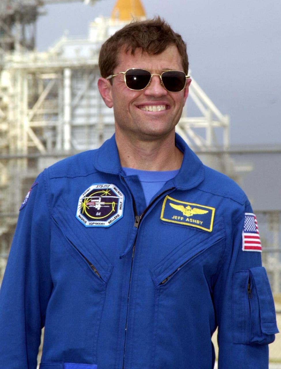 KENNEDY SPACE CENTER, FLA. - STS-112 Commander Jeffrey S. Ashby poses in front of Launch Pad 39B during a tour of Kennedy Space Center prior to launch. Also on the tour were the other members of the crew including Pilot Pamela Ann Melroy and Mission Specialists David A. Wolf, Sandra H. Magnus, Piers J. Sellers, and Fyodor N. Yurchikhin of the Russian Space Agency. The launch of Space Shuttle Atlantis was postponed today to no earlier than Thursday, Oct. 3, while weather forecasters and the mission management team assess the possible effect Hurricane Lili may have on the Mission Control Center located at the Lyndon B. Johnson Space Center in Houston, Texas.