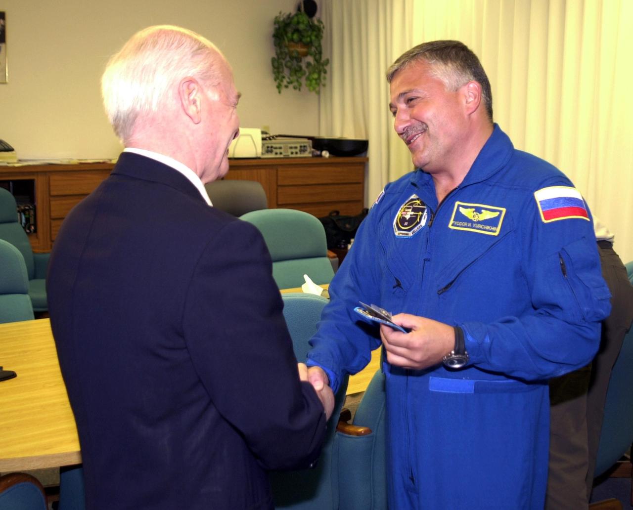 KENNEDY SPACE CENTER, FLA. - Aslan Abashidze, President of the Autonomous Republic of Ajara in Georgia (Russia) shakes hands with STS-112 Mission Specialist Fyodor N. Yurchikhin, Ph.D., (right) a cosmonaut with the Russian Space Agency.  Yurchikhin is at Kennedy Space Center awaiting his launch aboard Space Shuttle Atlantis on mission STS-112 to the International Space Station.  The launch has been postponed to no earlier than Monday, Oct. 7, so that the Mission Control Center, located at the Lyndon B. Johnson Space Center in Houston, Texas, can be secured and protected from potential storm impacts from Hurricane Lili.  
