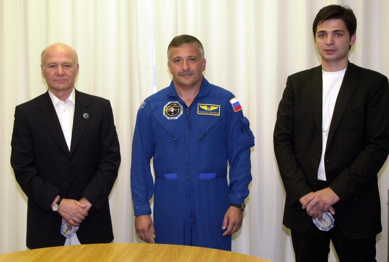 KENNEDY SPACE CENTER, FLA. - In the Operations and Checkout Building, Aslan Abashidze (left), President of the Autonomous Republic of Ajara in Georgia (Russia), STS-112 Mission Specialist Fyodor N. Yurchikhin, Ph.D., a cosmonaut with the Russian Space Agency; and Georgi Abashidze, Mayor of Batumi (Yurchikhin's hometown), pose for a portrait.  Yurchikhin and the other members of the STS-112 crew are awaiting launch to the International Space Station aboard Space Shuttle Atlantis.  The launch has been postponed to no earlier than Monday, Oct. 7, so that the Mission Control Center, located at the Lyndon B. Johnson Space Center in Houston, Texas, can be secured and protected from potential storm impacts from Hurricane Lili.  