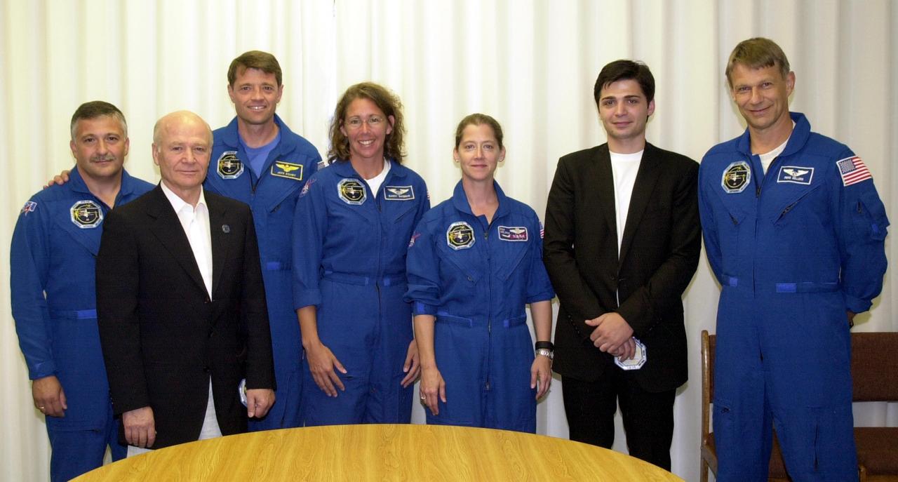 KENNEDY SPACE CENTER, FLA. - In the Operations and Checkout Building, the STS-112 crew takes time out from a visit with Russian officials to pose for a portrait.  From left are Mission Specialist Fyodor N. Yurchikhin, Ph.D., a cosmonaut with the Russian Space Agency; Aslan Abashidze, President of the Autonomous Republic of Ajara in Georgia (Russia); Commander Jeffrey S. Ashby; Mission Specialist Sandra H. Magnus, Ph.D.; Pilot Pamela Ann Melroy; Georgi Abashidze, Mayor of Batumi (Yurchikhin's hometown); and Mission Specialist Piers J. Sellers, Ph.D.  Mission Specialist David A. Wolf, M.D., not pictured, is also a member of the crew.  The STS-112 crew is awaiting launch to the International Space Station aboard Space Shuttle Atlantis.  The launch has been postponed to no earlier than Monday, Oct. 7, so that the Mission Control Center, located at the Lyndon B. Johnson Space Center in Houston, Texas, can be secured and protected from potential storm impacts from Hurricane Lili.  