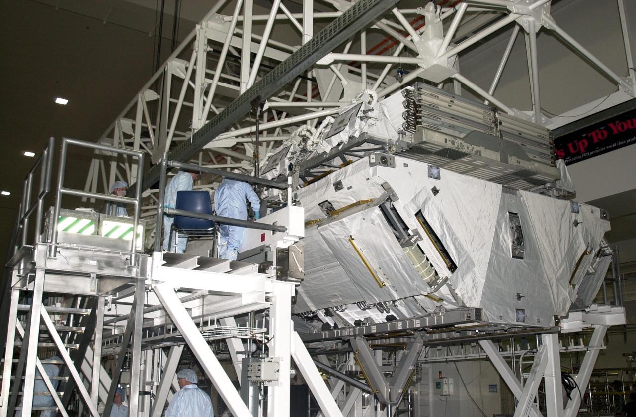 KENNEDY SPACE CENTER, FLA. -- Inside the Space Station Processing Facility, technicians prepare the P1 Truss Segment to be hooked to the overhead crane and moved toward the payload canister. The P1 truss is the primary payload for Mission STS-113. It is the first port truss segment which will be attached to the Station’s central truss segment, S0. Once delivered, the P1 truss will remain stowed until flight 12A.1. The mission will also deliver the Expedition 6 crew to the Station and return Expedition 5 to Earth. Space Shuttle Endeavour is scheduled to launch no earlier than Nov. 10 on the 11-day mission.