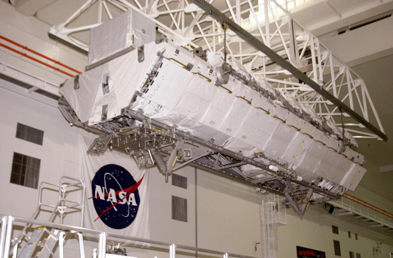 KENNEDY SPACE CENTER, FLA. -- Inside the Space Station Processing Facility, the P1 Truss Segment is moved by overhead crane through the highbay toward the payload canister. The P1 truss is the primary payload for Mission STS-113. It is the first port truss segment which will be attached to the Station’s central truss segment, S0. Once delivered, the P1 truss will remain stowed until flight 12A.1. The mission will also deliver the Expedition 6 crew to the Station and return Expedition 5 to Earth. Space Shuttle Endeavour is scheduled to launch no earlier than Nov. 10 on the 11-day mission.