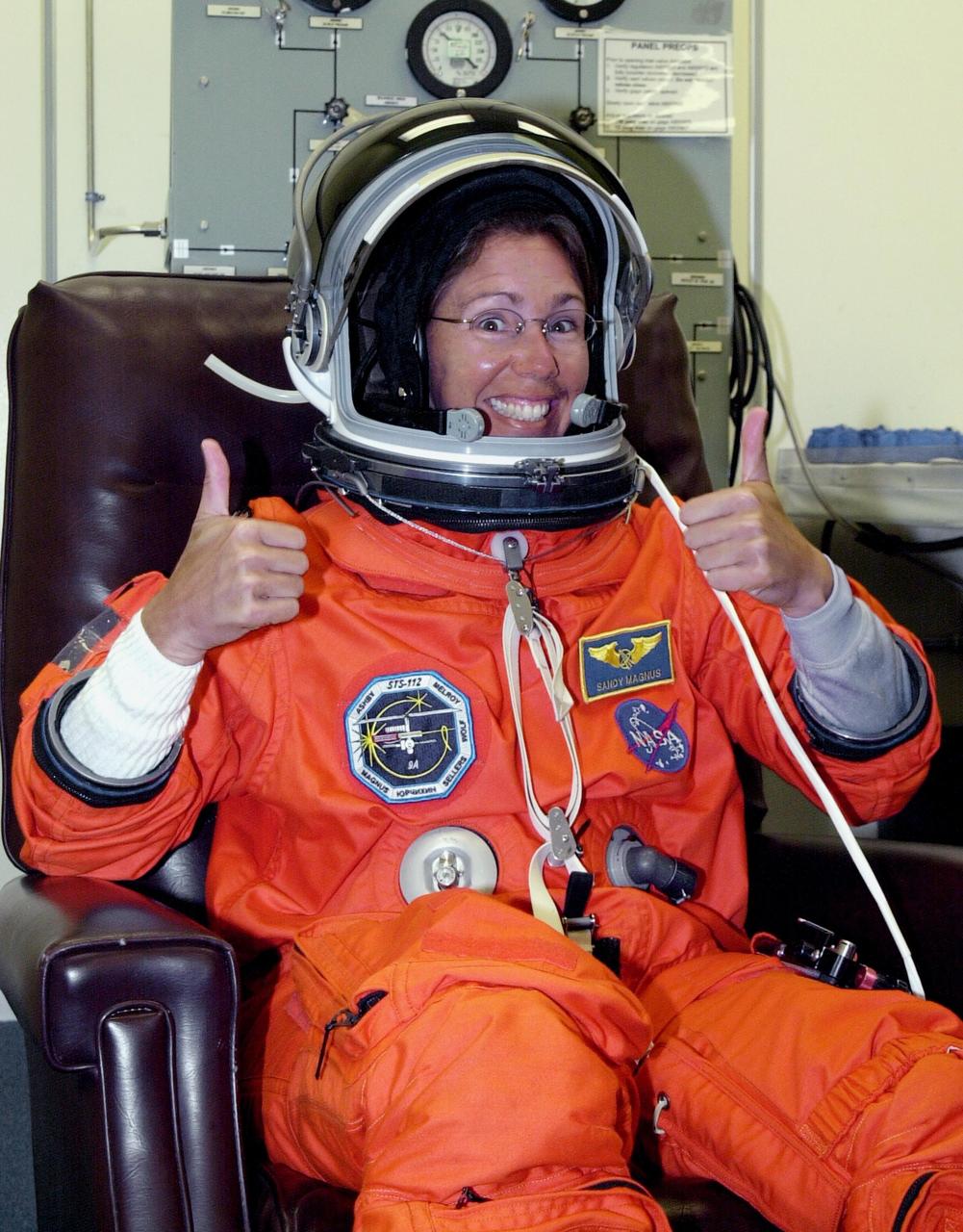 KENNEDY SPACE CENTER, FLA. -   STS-112 Mission Specialist Sandra Magnus finishes suiting up before launch.  STS-112 is the 15th assembly flight to the International Space Station, carrying the S1 Integrated Truss Structure and the Crew and Equipment Translation Aid (CETA) Cart A.  The CETA is the first of two human-powered carts that will ride along the ISS railway, providing mobile work platforms for future spacewalking astronauts.  On the 11-day mission, three spacewalks are planned to attach the S1 truss to the Station.   Launch is scheduled for 3:46 p.m. EDT from Launch Pad 39B.  