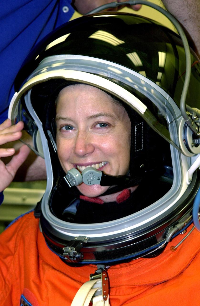 KENNEDY SPACE CENTER, FLA. --  STS-112 Pilot Pamela Melroy finishes suiting up for launch. STS-112 is the 15th assembly flight to the International Space Station, carrying the S1 Integrated Truss Structure and the Crew and Equipment Translation Aid (CETA) Cart A.  The CETA is the first of two human-powered carts that will ride along the ISS railway, providing mobile work platforms for future spacewalking astronauts.  On the 11-day mission, three spacewalks are planned to attach the S1 truss to the Station.   Launch is scheduled for 3:46 p.m. EDT from Launch Pad 39B.  .