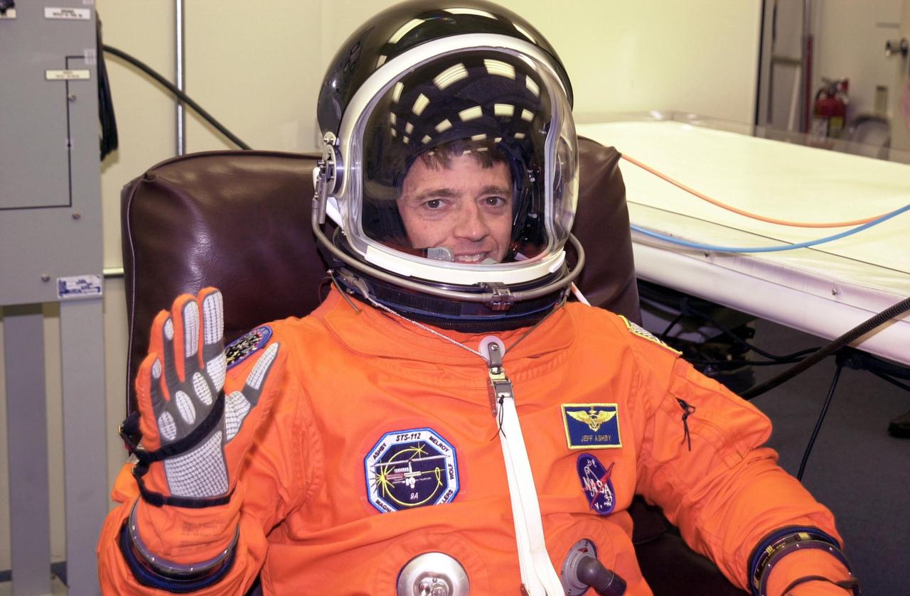 KENNEDY SPACE CENTER, FLA. -- STS-112 Commander Jeffrey Ashby finishes suiting up for launch. STS-112 is the 15th assembly flight to the International Space Station, carrying the S1 Integrated Truss Structure and the Crew and Equipment Translation Aid (CETA) Cart A. The CETA is the first of two human-powered carts that will ride along the ISS railway, providing mobile work platforms for future spacewalking astronauts. On the 11-day mission, three spacewalks are planned to attach the S1 truss to the Station. Launch is scheduled for 3:46 p.m. EDT from Launch Pad 39B.