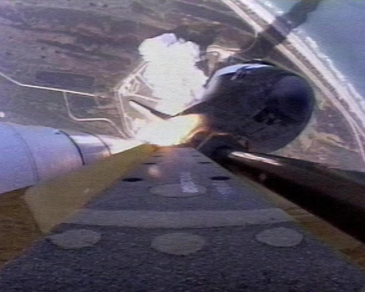 KENNEDY SPACE CENTER, FLA. -- The view from the External Tank camera shows a cloud of smoke and steam on the pad below as Space Shuttle Atlantis hurtles into space on mission STS-112. The Atlantic Ocean laps the shore on the right. Liftoff from Launch Pad 39B occurred at 3:46 p.m. EDT. Atlantis carries the S1 Integrated Truss Structure and the Crew and Equipment Translation Aid (CETA) Cart A. The CETA is the first of two human-powered carts that will ride along the ISS railway, providing mobile work platforms for future spacewalking astronauts. On the 11-day mission, three spacewalks are planned to attach the S1 truss.