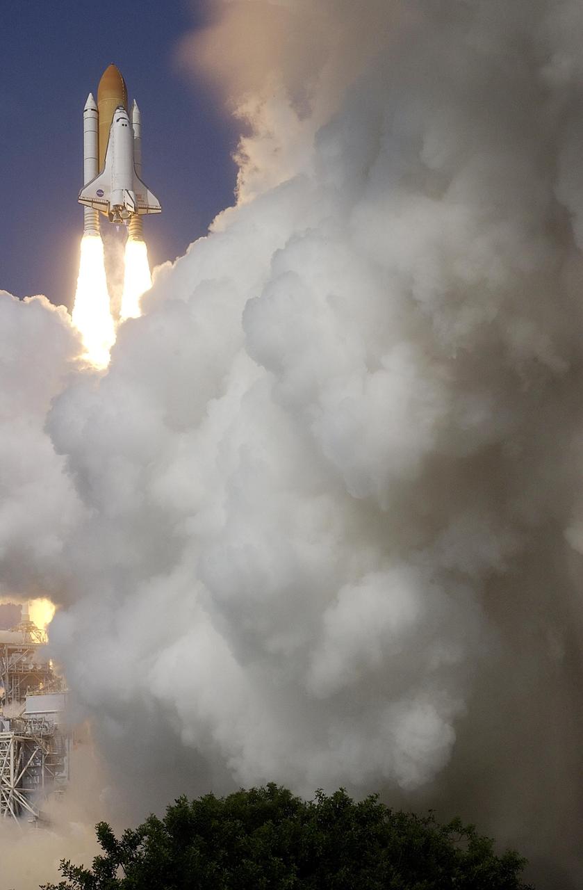KENNEDY SPACE CENTER, FLA. --  Rising clouds of smoke and steam appear to surround Space Shuttle Atlantis as it hurtles toward space on mission STS-112.  Liftoff occurred on time at 3:46 p.m. EDT. Along with a crew of six, Atlantis carries the S1 Integrated Truss Structure and the Crew and Equipment Translation Aid (CETA) Cart A.  The CETA is the first of two human-powered carts that will ride along the ISS railway, providing mobile work platforms for future spacewalking astronauts.  On the 11-day mission, three spacewalks are planned to attach the S1 truss. [Photo courtesy of Scott Andrews]