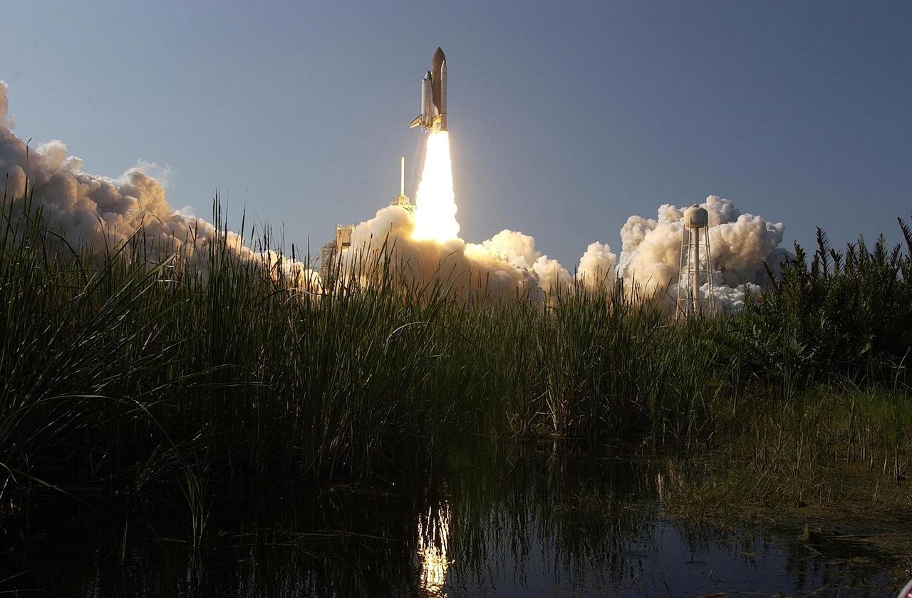 KENNEDY SPACE CENTER, FLA. -- The brilliance of the launch of Space Shuttle Atlantis is reflected in nearby waters. Liftoff of the Shuttle on mission STS-112 occurred on time at 3:46 p.m. EDT. Along with a crew of six, Atlantis carries the S1 Integrated Truss Structure and the Crew and Equipment Translation Aid (CETA) Cart A.  The CETA is the first of two human-powered carts that will ride along the ISS railway, providing mobile work platforms for future spacewalking astronauts.  On the 11-day mission, three spacewalks are planned to attach the S1 truss. [Photo courtesy of Scott Andrews]