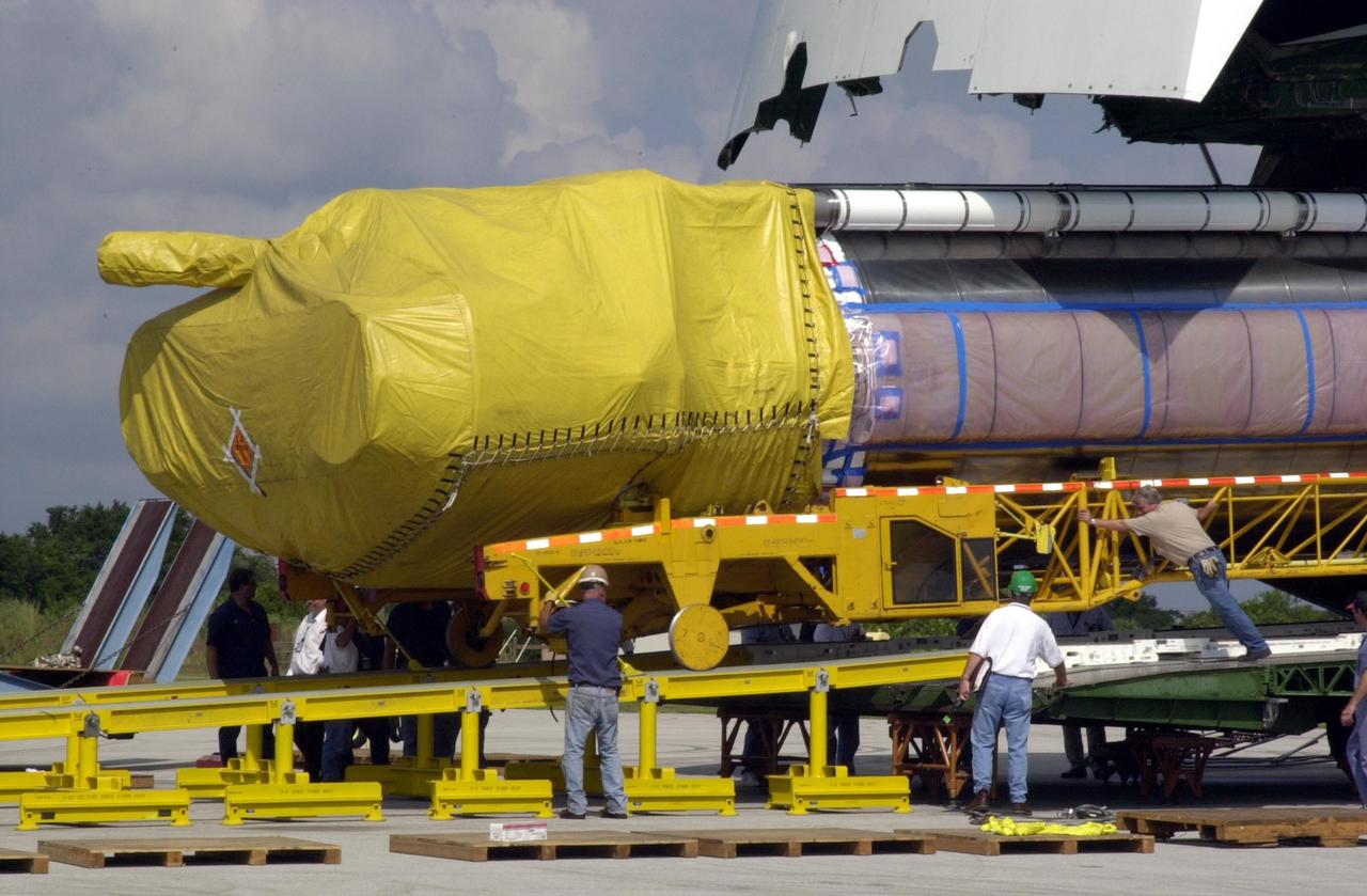 KENNEDY SPACE CENTER, FLA.  -- An Atlas/Centaur booster is moved away from the nose of its transport aircraft following its arrival at Cape Canaveral Air Force Station. The booster is being offloaded and readied for the move to Launch Pad 36A in preparation for the launch of TDRS-J. The third in a series of telemetry satellites, TDRS-J will help replenish the current constellation of geosynchronous TDRS satellites. The TDRS System is the primary source of space-to-ground voice, data and telemetry for the Space Shuttle. It also provides communications with the International Space Station and scientific spacecraft in low-Earth orbit such as the Hubble Space Telescope. This new advanced series of satellites will extend the availability of TDRS communications services until about 2017. 