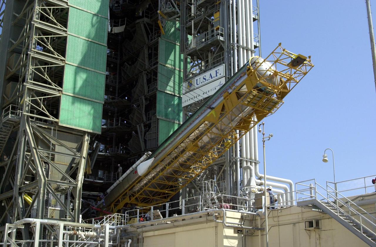 KENNEDY SPACE CENTER, FLA.  -- The first stage of an Atlas/Centaur booster (AC-144) is lifted into an upright position at Launch Complex 36A at Cape Canaveral Air Force Station in preparation for the launch of TDRS-J. The third in a series of telemetry satellites, TDRS-J will help replenish the current constellation of geosynchronous TDRS satellites. The TDRS System is the primary source of space-to-ground voice, data and telemetry for the Space Shuttle. It also provides communications with the International Space Station and scientific spacecraft in low-Earth orbit, such as the Hubble Space Telescope. This new advanced series of satellites will extend the availability of TDRS communications services until about 2017.