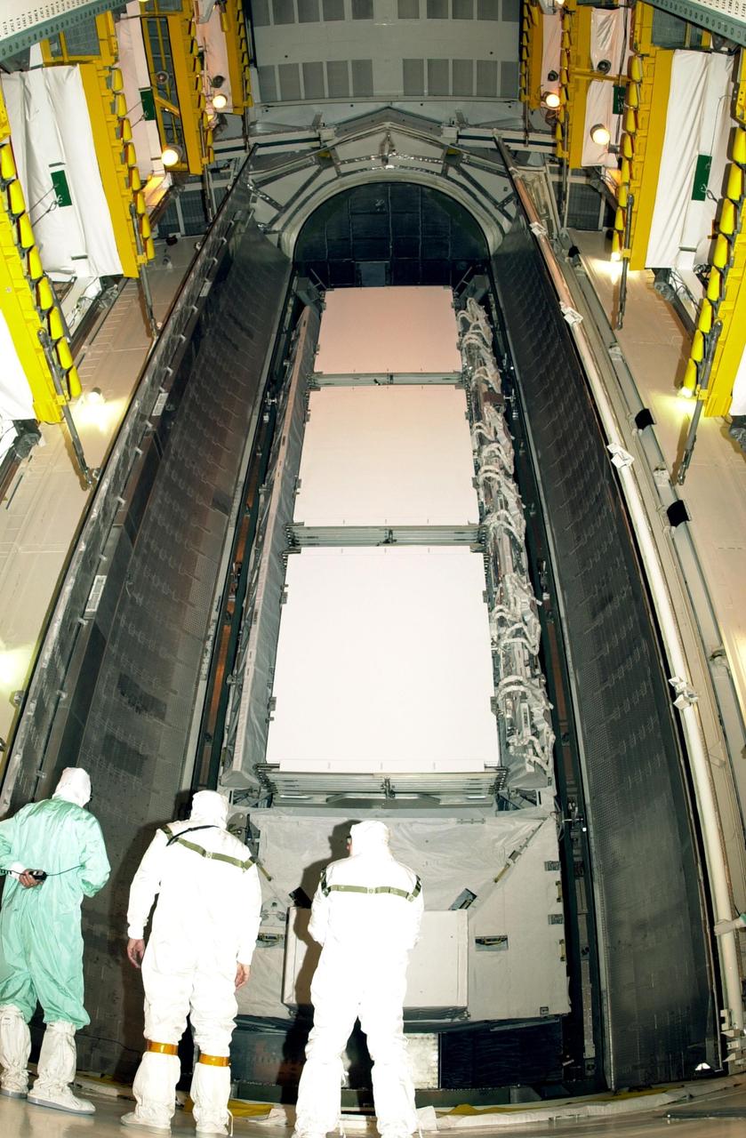 KENNEDY SPACE CENTER, FLA. -- At Launch Complex 39A, technicians in the Payload Changout Room supervise the opening of the payload canister doors for transfer of the P1 truss. The P1 truss is the primary payload for Mission STS-113 to the International Space Station. It is the first port truss segment which will be attached to the Station’s central truss segment, S0. Once delivered, the P1 truss will remain stowed until flight 12A.1. The mission will also deliver the Expedition 6 crew to the Station and return Expedition 5 to Earth. Space Shuttle Endeavour is scheduled to launch no earlier than Nov. 10 on the 11-day mission.