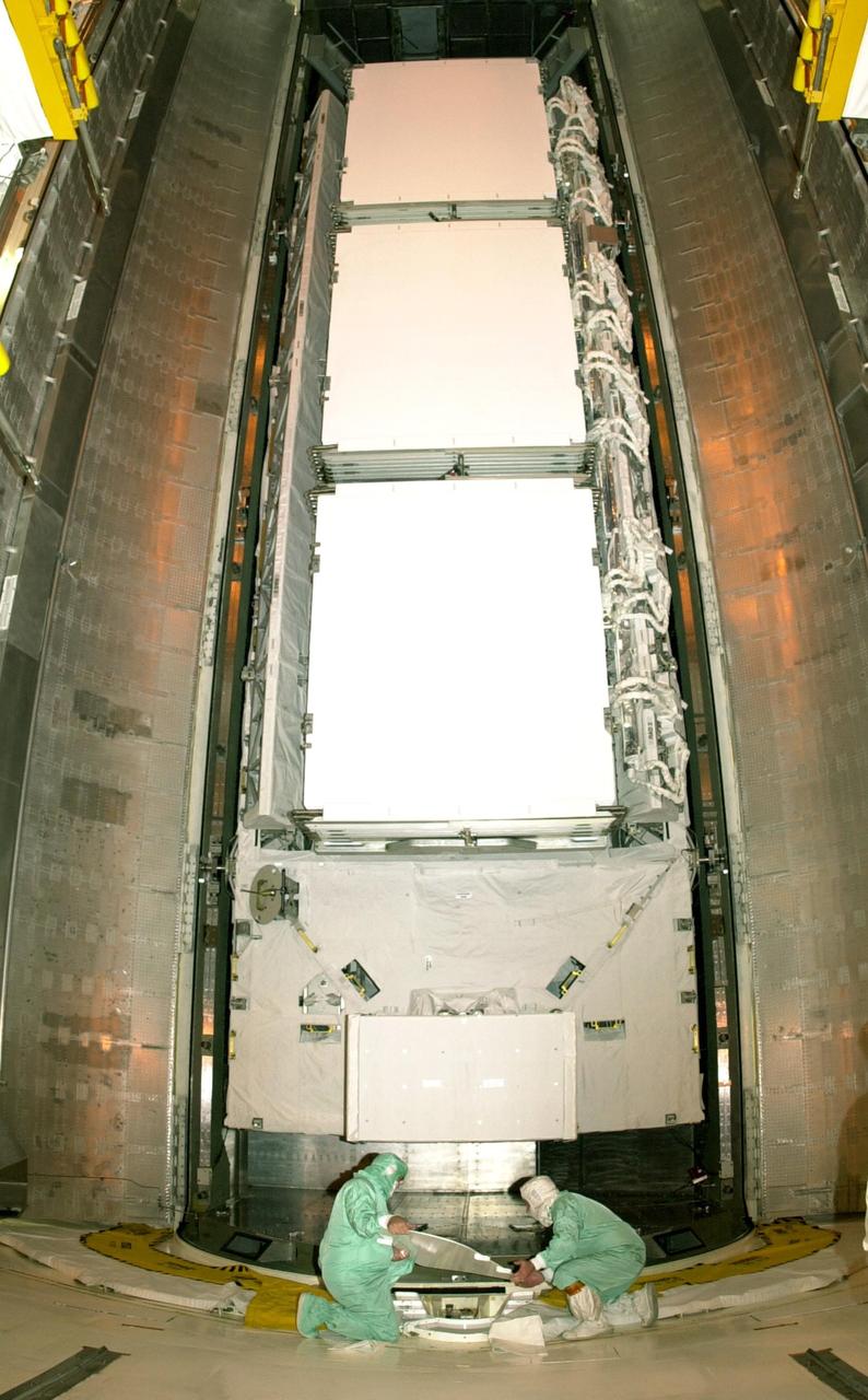 KENNEDY SPACE CENTER, FLA. -- At Launch Complex 39A, technicians prepare to move the P1 truss segment from the payload canister into the Payload Changeout Room. The P1 truss is the primary payload for Mission STS-113 to the International Space Station. It is the first port truss segment which will be attached to the Station’s central truss segment, S0. Once delivered, the P1 truss will remain stowed until flight 12A.1. The mission will also deliver the Expedition 6 crew to the Station and return Expedition 5 to Earth. Space Shuttle Endeavour is scheduled to launch no earlier than Nov. 10 on the 11-day mission.