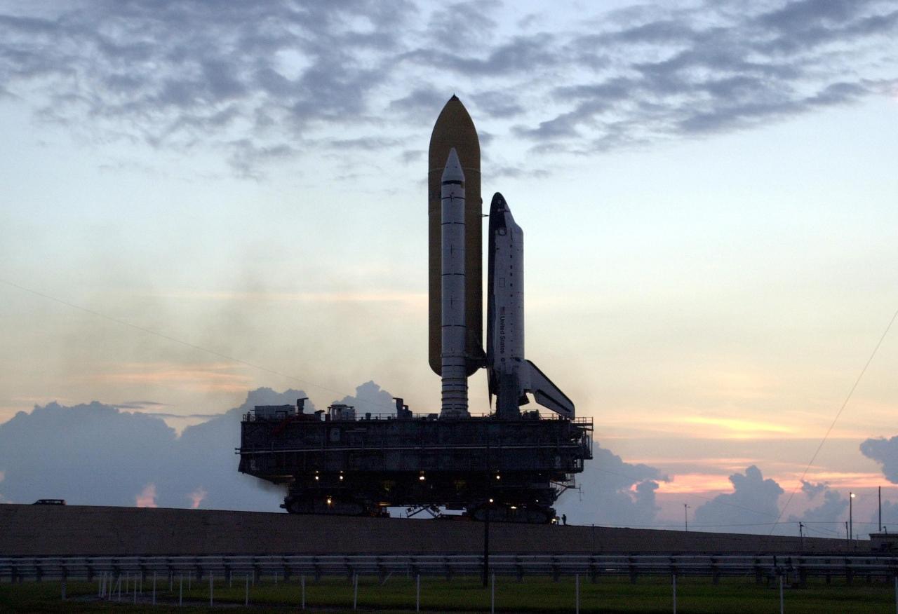KENNEDY SPACE CENTER, FLA. - Against a lavender and pink dawn sky, Space Shuttle Endeavour inches up the ramp of Launch Pad 39A after its rollout from the Vehicle Assembly Building. The Shuttle sits atop the Mobile Launcher Platform and is transported by the crawler-transporter underneath. Endeavour is scheduled to launch Nov. 10 on mission STS-113, the 16th assembly flight to the International Space Station. The primary payloads on mission STS-113 are the first port truss segment, P1 Truss, and the Crew and Equipment Translation Aid (CETA) Cart B. Once delivered, the P1 truss will remain stowed until flight 12A.1 in 2003 when it will be attached to the central truss segment, S0, on the Space Station. The mission will also deliver the Expedition 6 crew to the Station and return Expedition 5 to Earth.