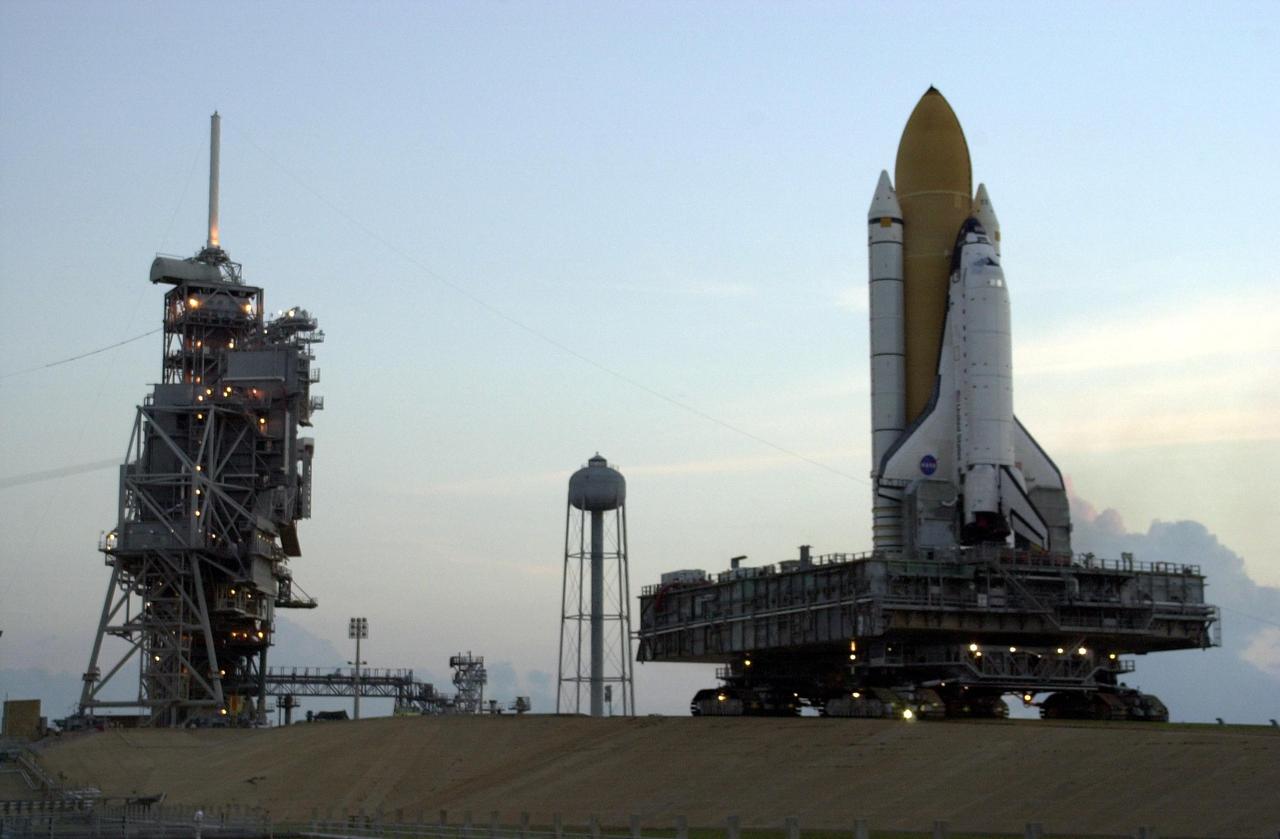 KENNEDY SPACE CENTER, FLA. -- With a brightening sky at dawn in the background, Space Shuttle Endeavour nears the top of Launch Pad 39A after rollout from the Vehicle Assembly Building. The Shuttle sits atop the Mobile Launcher Platform and is transported by the crawler-transporter underneath. Endeavour is scheduled to launch Nov. 10 on mission STS-113, the 16th assembly flight to the International Space Station. The primary payloads on mission STS-113 are the first port truss segment, P1 Truss, and the Crew and Equipment Translation Aid (CETA) Cart B. Once delivered, the P1 truss will remain stowed until flight 12A.1 in 2003 when it will be attached to the central truss segment, S0, on the Space Station. The mission will also deliver the Expedition 6 crew to the Station and return Expedition 5 to Earth.