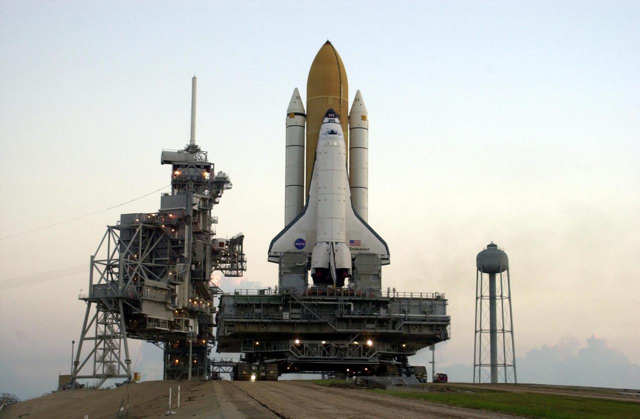 KENNEDY SPACE CENTER, FLA. -- In the early morning, Space Shuttle Endeavour approaches the Rotating and Fixed Service Structures on Launch Pad 39A after rollout from the Vehicle Assembly Building. The Shuttle sits atop the Mobile Launcher Platform and is transported by the crawler-transporter underneath. Endeavour is scheduled to launch Nov. 10 on mission STS-113, the 16th assembly flight to the International Space Station. The primary payloads on mission STS-113 are the first port truss segment, P1 Truss, and the Crew and Equipment Translation Aid (CETA) Cart B. Once delivered, the P1 truss will remain stowed until flight 12A.1 in 2003 when it will be attached to the central truss segment, S0, on the Space Station. The mission will also deliver the Expedition 6 crew to the Station and return Expedition 5 to Earth.