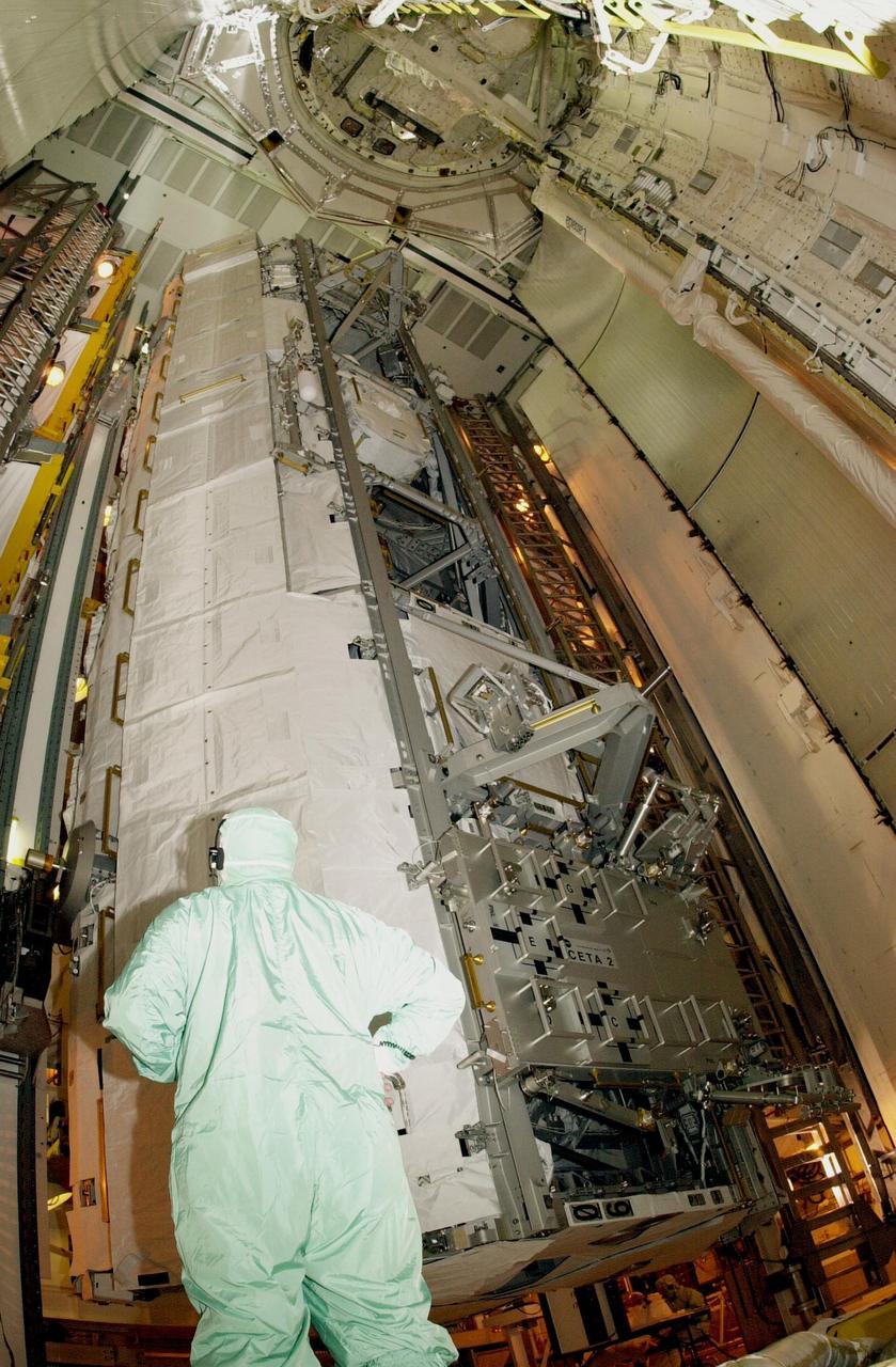 KENNEDY SPACE CENTER, FLA. --  A worker in the Payload Changeout Room on Launch Pad 39A watches as the P1 truss payload, plus the Crew and Equipment Translation Aid  (CETA) cart B, move into the payload bay of Space Shuttle Endeavour.  Scheduled to launch Nov. 10 on mission STS-113, Endeavour will make the 16th assembly flight to the International Space Station.  Once delivered, the P1 truss will remain stowed until flight 12A.1 in 2003 when it will be attached to the central truss segment, S0, on the Space Station.  The mission will also deliver the Expedition 6 crew to the Station and return Expedition 5 to Earth.