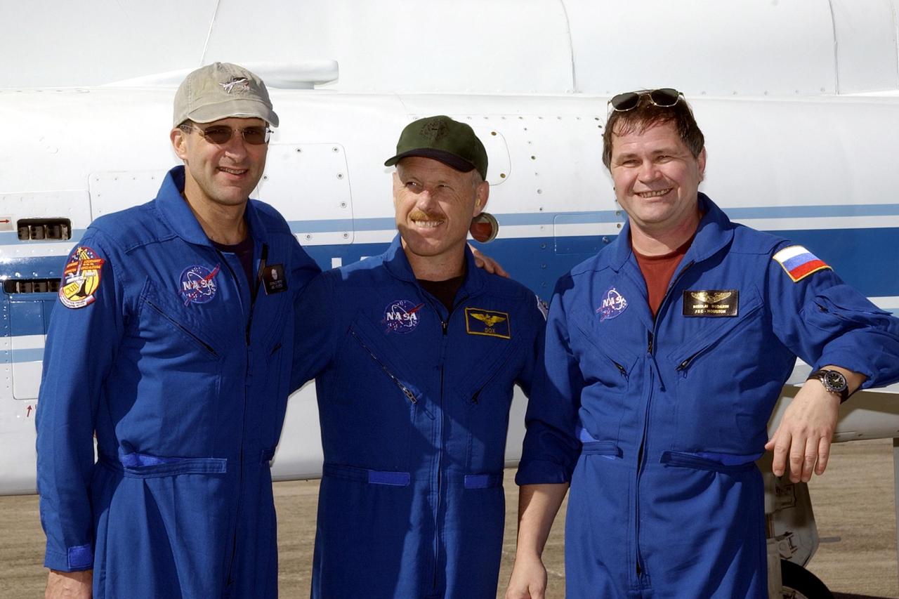 KENNEDY SPACE CENTER, FLA. --  The Expedition 6 crew pauses for the photographer after their arrival at the Shuttle Landing Facility.  From left are astronaut Donald Pettit, Commander Ken Bowersox and cosmonaut Nikolai Budarin.  The crew is at KSC for Terminal Countdown Demonstration Test activities.   Expedition 6 will fly on Space Shuttle Endeavour to the International Space Station on mission STS-113.  They will relieve and replace the Expedition 5 crew.  Endeavour will also be transporting the Port 1 (P1) truss segment to the Station.  STS-113 is scheduled to launch Nov. 10, 2002.