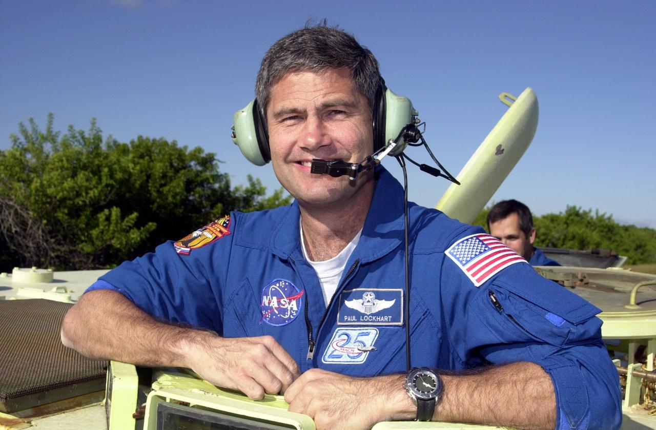 KENNEDY SPACE CENTER, FLA. -- STS-113 Pilot Paul Lockhart stands inside an M-113 armored personnel carrier he is about to drive, part of emergency egress training during Terminal Countdown Demonstration Test activities. He and the rest of the crew are preparing for the mission aboard Space Shuttle Endeavour, which is scheduled to launch Nov. 10. The TCDT includes a simulated launch countdown. The primary payloads on mission STS-113 are the first port truss segment, P1, and the Crew and Equipment Translation Aid (CETA) Cart B. Once delivered, the P1 truss will remain stowed until flight 12A.1 in 2003 when it will be attached to the central truss segment, S0, on the Space Station. Also onboard Space Shuttle Endeavour will be the Expedition 6 crew who will replace Expedition 5, returning to Earth after 4 months.