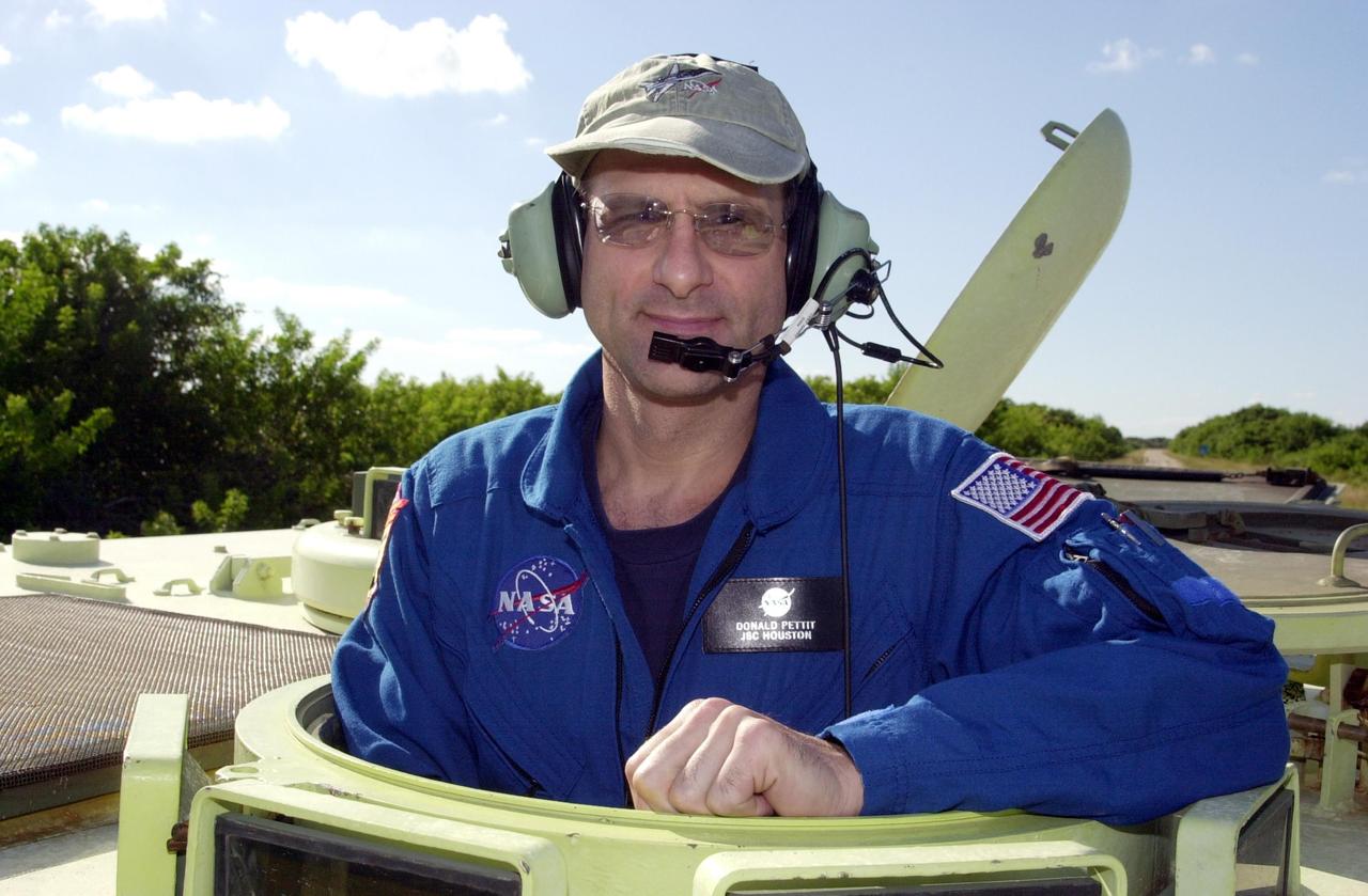 KENNEDY SPACE CENTER, FLA. -- During emergency egress training at the pad, Expedition 6 crew member Donald Pettit stands inside an M-113 armored personnel carrier before his practice drive. The training is part of Terminal Countdown Demonstration Test activities in preparation for launch. The TCDT also includes a simulated launch countdown. The Expedition 6 crew will travel on Space Shuttle Endeavour to the International Space Station to replace Expedition 5, returning to Earth after 4 months. The primary payloads on mission STS-113 are the first port truss segment, P1, and the Crew and Equipment Translation Aid (CETA) Cart B. Once delivered, the P1 truss will remain stowed until flight 12A.1 in 2003 when it will be attached to the central truss segment, S0, on the Space Station. Launch is scheduled for Nov. 10, 2002.
