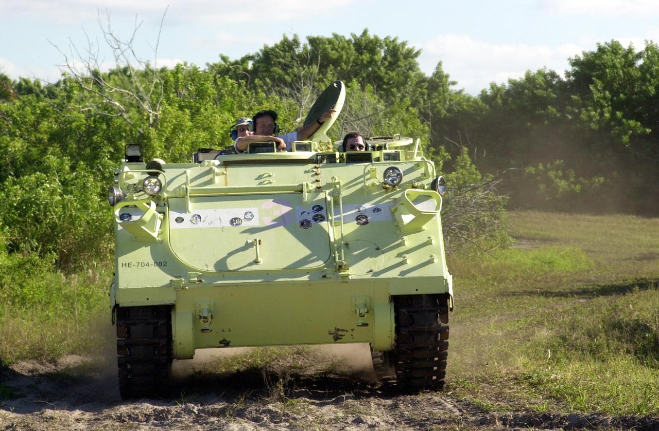 KENNEDY SPACE CENTER, FLA. -- Expedition 6 crew member Nikolai Budarin takes his turn driving an M-113 armored personnel carrier during emergency egress training at the pad. The crew is preparing for the mission aboard Space Shuttle Endeavour, which is scheduled to launch Nov. 10, by taking part in Terminal Countdown Demonstration Test activities. The TCDT includes a simulated launch countdown.. The Expedition 6 crew will travel on Space Shuttle Endeavour to the International Space Station to replace Expedition 5, returning to Earth after 4 months. The primary payloads on mission STS-113 are the first port truss segment, P1, and the Crew and Equipment Translation Aid (CETA) Cart B. Once delivered, the P1 truss will remain stowed until flight 12A.1 in 2003 when it will be attached to the central truss segment, S0, on the Space Station. Launch is scheduled for Nov. 10, 2002.