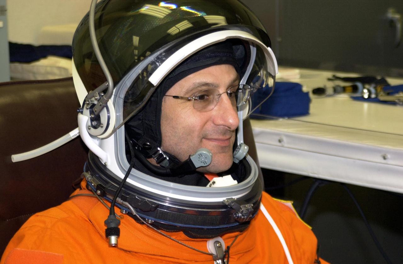 KENNEDY SPACE CENTER, FLA. -- STS-113 Mission Specialist Donald Pettit smiles during fit check of his helmet, part of Terminal Countdown Demonstration Test activities. He and the rest of the crew are preparing for the mission aboard Space Shuttle Endeavour, which is scheduled to launch Nov. 10. The TCDT includes emergency egress training and a launch countdown. The primary payloads on mission STS-113 are the first port truss segment, P1, and the Crew and Equipment Translation Aid (CETA) Cart B. Once delivered, the P1 truss will remain stowed until flight 12A.1 in 2003 when it will be attached to the central truss segment, S0, on the Space Station. Also onboard Space Shuttle Endeavour will be the Expedition 6 crew who will replace Expedition 5, returning to Earth after 4 months.