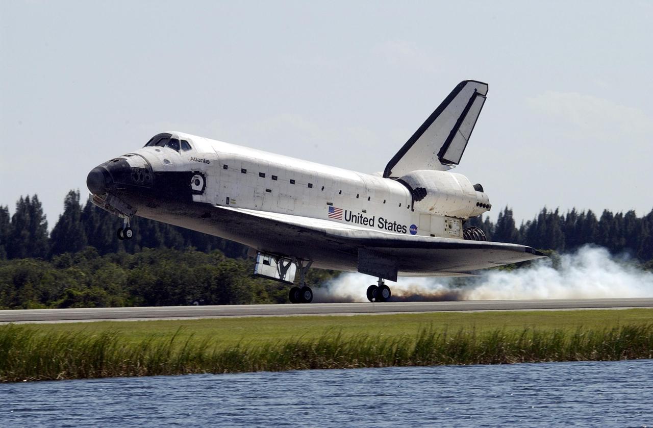 KENNEDY SPACE CENTER, FLA. --   Space Shuttle Atlantis kicks up dust as it touches down at the Shuttle Landing Facility, completing the 4.5-million-mile journey to the International Space Station.  Main gear touchdown occurred at 11:43:40 a.m. EDT; nose gear touchdown at 11:43:48 a.m.; and wheel stop at 11:44:35 a.m.  Mission elapsed time was 10:19:58:44.  Mission STS-112 expanded the size of the Station with the addition of the S1 truss segment.  The returning crew of Atlantis are Commander Jeffrey Ashby, Pilot Pamela Melroy, and Mission Specialists David Wolf, Piers Sellers, Sandra Magnus and Fyodor Yurchikhin. This landing is the 60th at KSC in the history of the Shuttle program.  