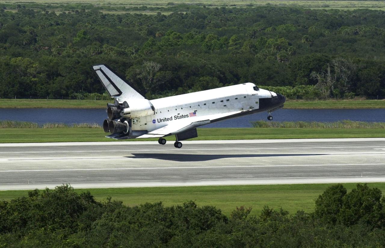 KENNEDY SPACE CENTER, FLA. - Its shadow precedes it as Space Shuttle Atlantis drops to the runway at the Shuttle Landing Facility, completing the 4.5-million-mile journey to the International Space Station.  Main gear touchdown occurred at 11:43:40 a.m. EDT; nose gear touchdown at 11:43:48 a.m.; and wheel stop at 11:44:35 a.m.  Mission elapsed time was 10:19:58:44.  Mission STS-112 expanded the size of the Station with the addition of the S1 truss segment.  The returning crew of Atlantis are Commander Jeffrey Ashby, Pilot Pamela Melroy, and Mission Specialists David Wolf, Piers Sellers, Sandra Magnus and Fyodor Yurchikhin. This landing is the 60th at KSC in the history of the Shuttle program.      .    