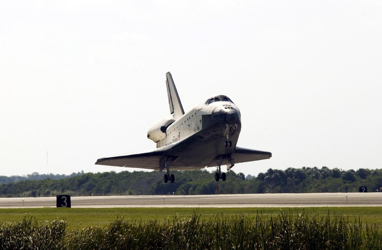 KENNEDY SPACE CENTER, FLA. -- Space Shuttle Atlantis approaches the runway at the Shuttle Landing Facility, completing the 4.5-million-mile journey to the International Space Station.  Main gear touchdown occurred at 11:43:40 a.m. EDT; nose gear touchdown at 11:43:48 a.m.; and wheel stop at 11:44:35 a.m.  Mission elapsed time was 10:19:58:44.  Mission STS-112 expanded the size of the Station with the addition of the S1 truss segment.  The returning crew of Atlantis are Commander Jeffrey Ashby, Pilot Pamela Melroy, and Mission Specialists David Wolf, Piers Sellers, Sandra Magnus and Fyodor Yurchikhin. This landing is the 60th at KSC in the history of the Shuttle program.       .    